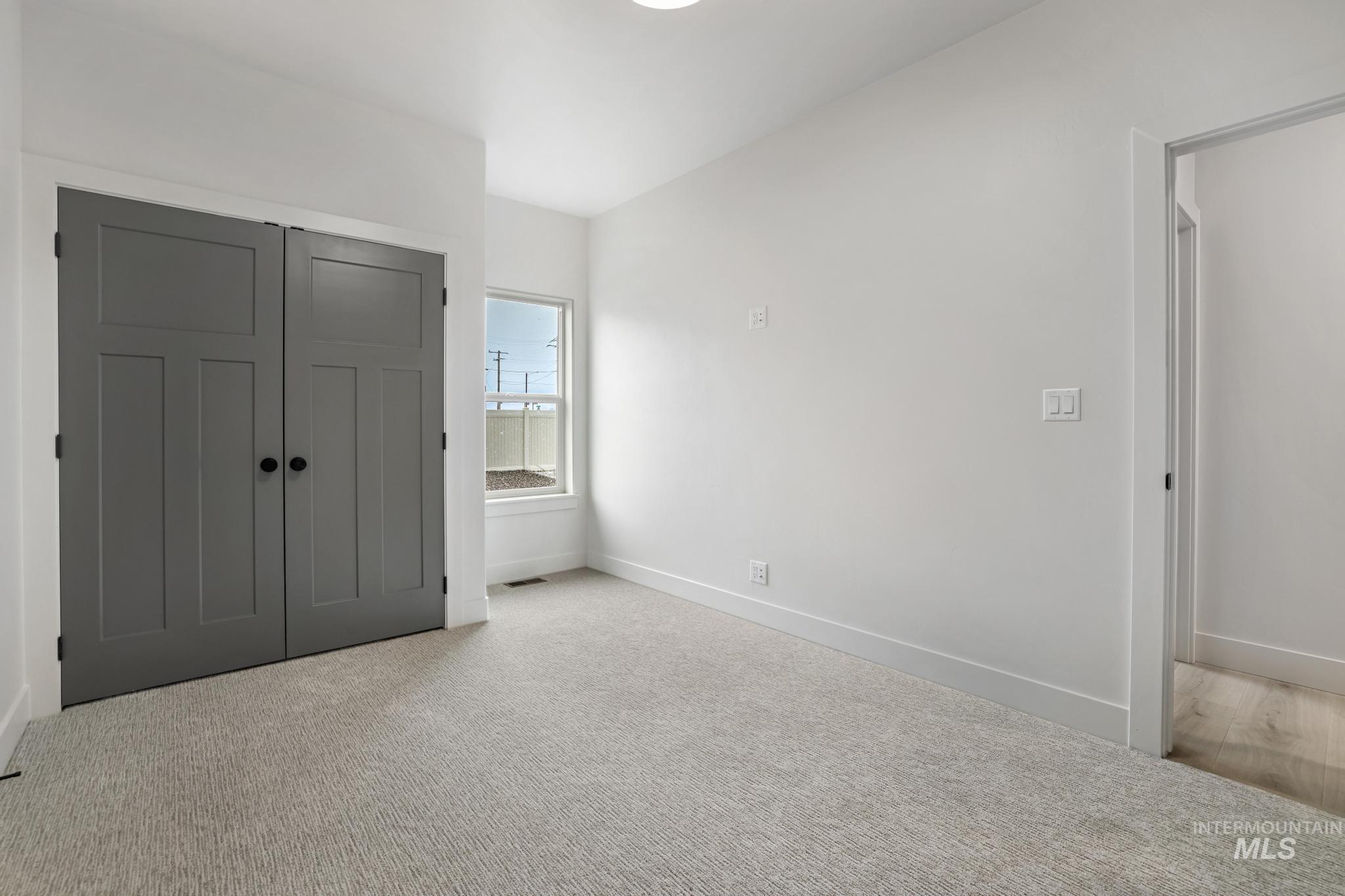 Unfurnished bedroom with a closet and carpet floors