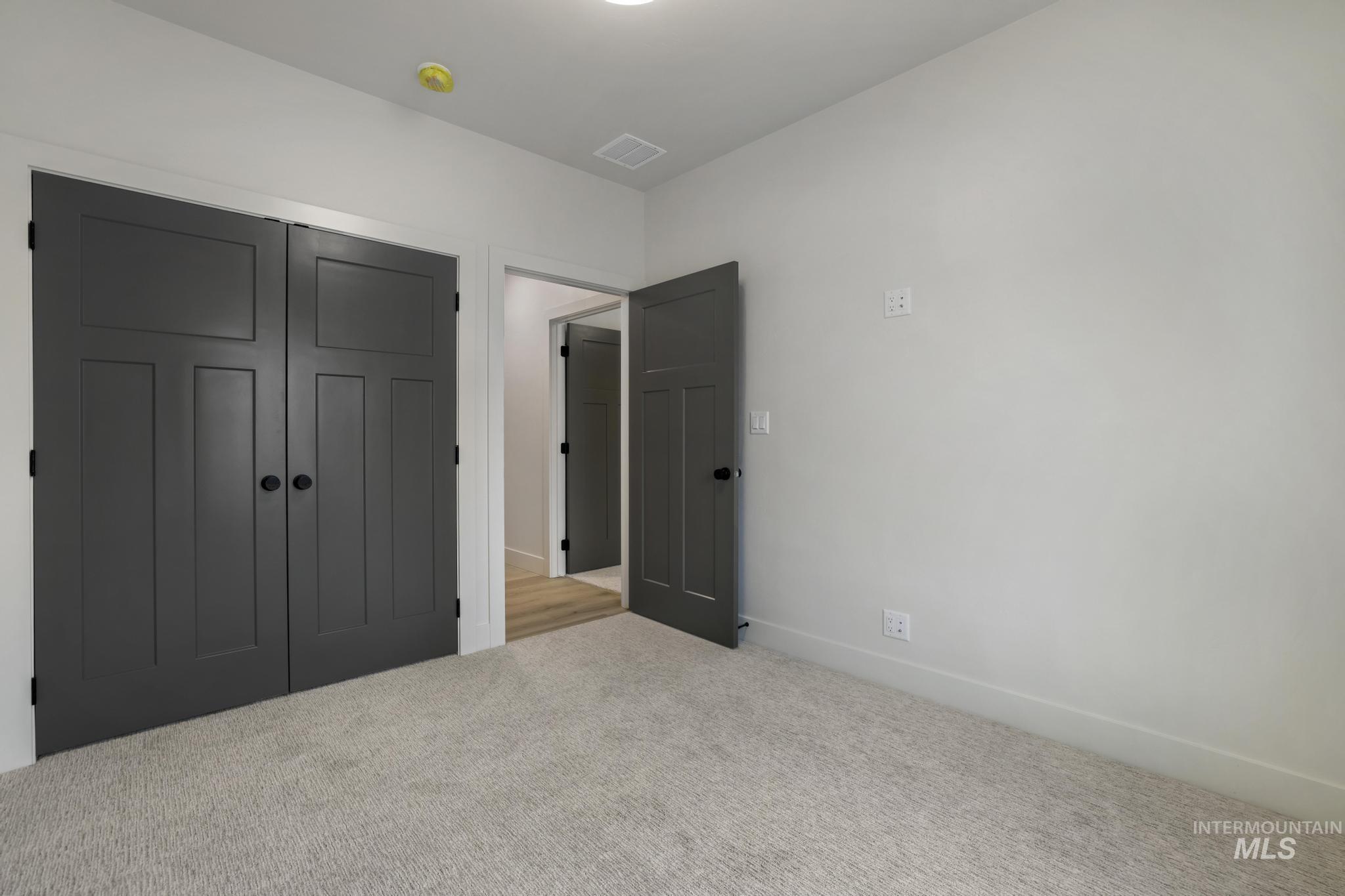 Unfurnished bedroom with a closet and carpet
