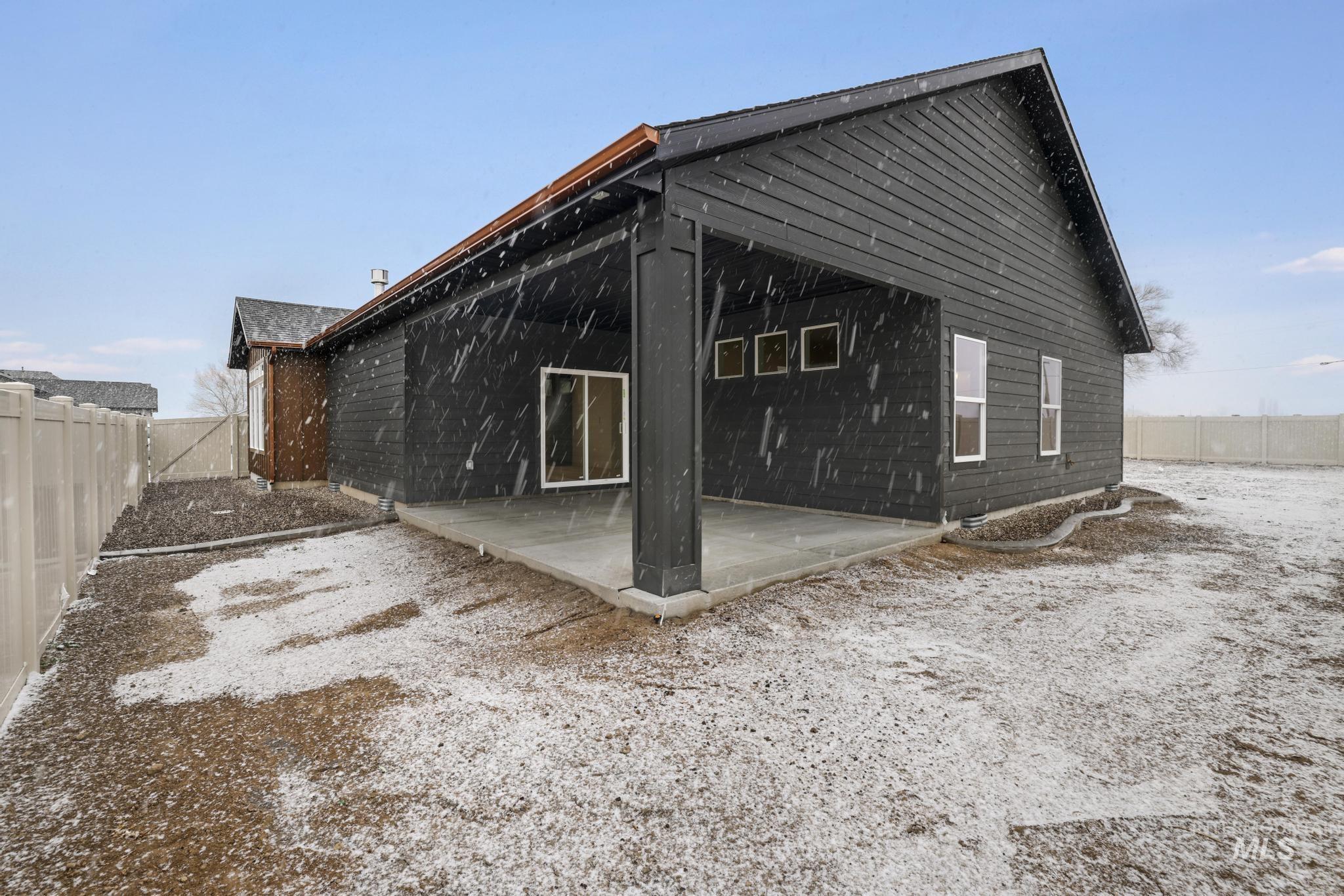 Back of house featuring a fenced backyard and a patio
