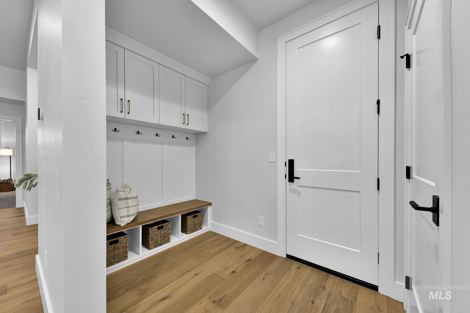 Mudroom with baseboards and light wood-style flooring