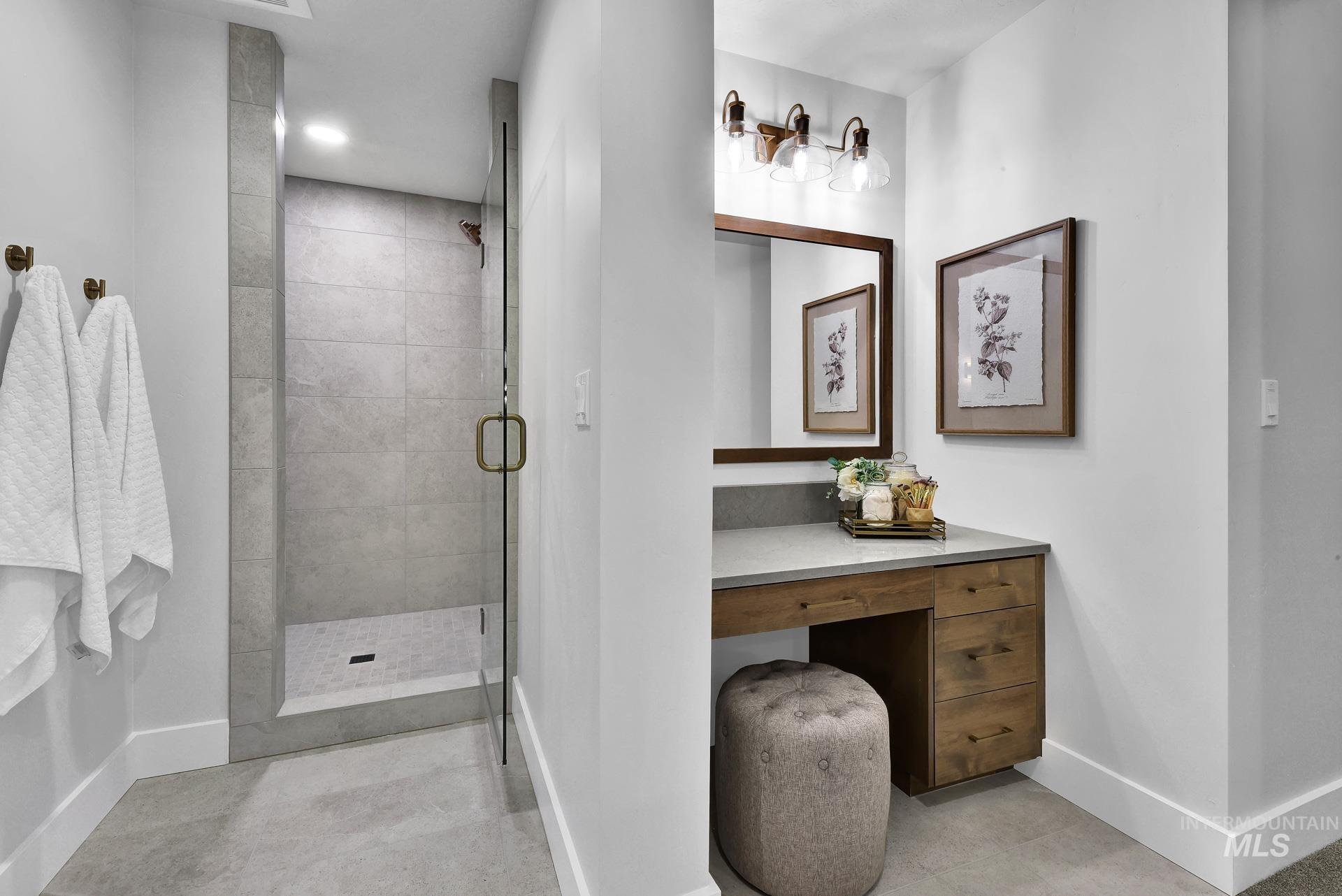 Bathroom featuring baseboards and a shower stall