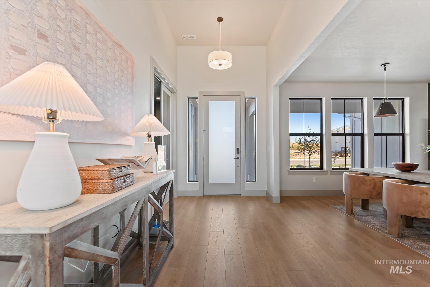 Foyer with light wood-style floors and baseboards