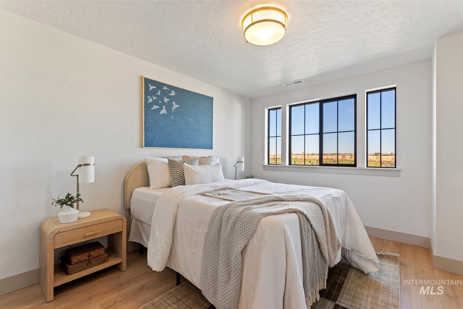 Bedroom featuring light wood-style flooring and a textured ceiling