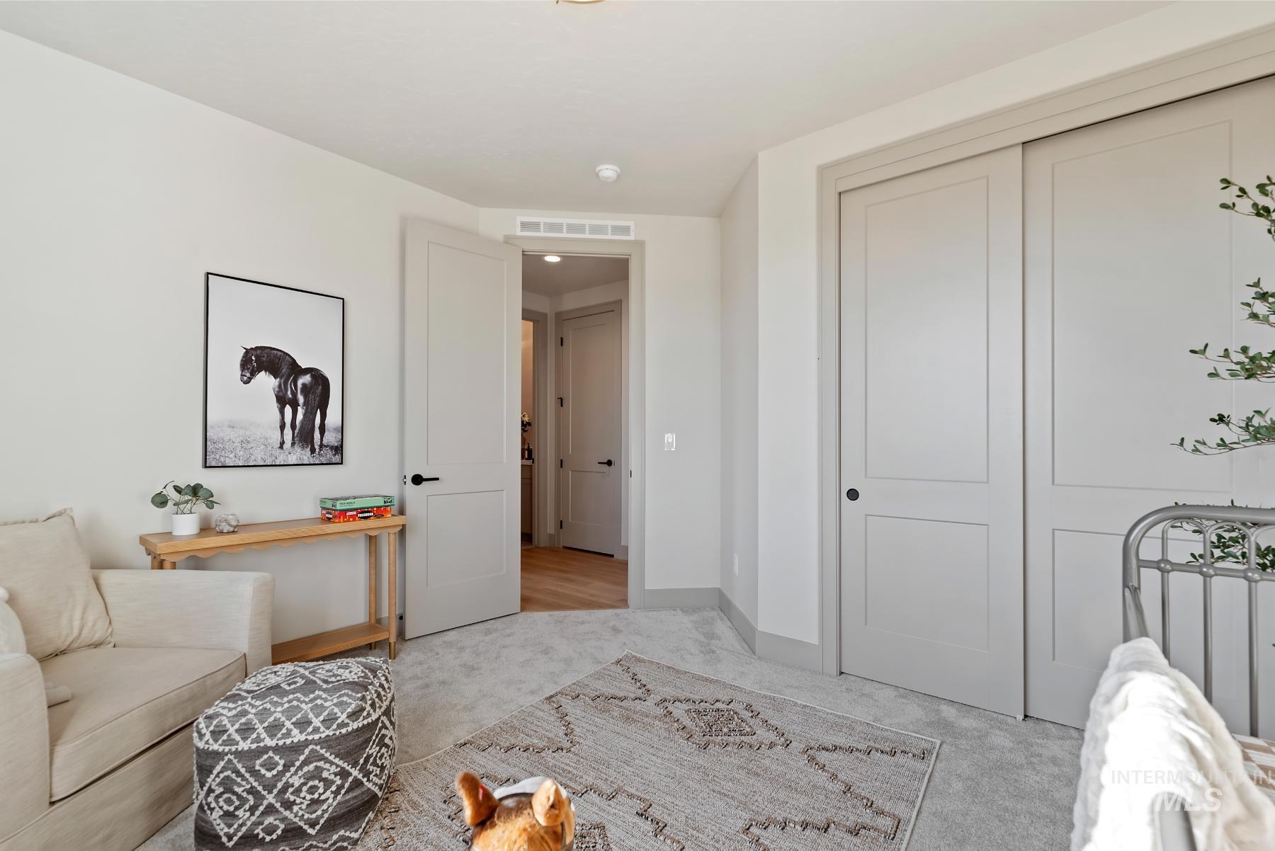 Sitting room featuring light colored carpet