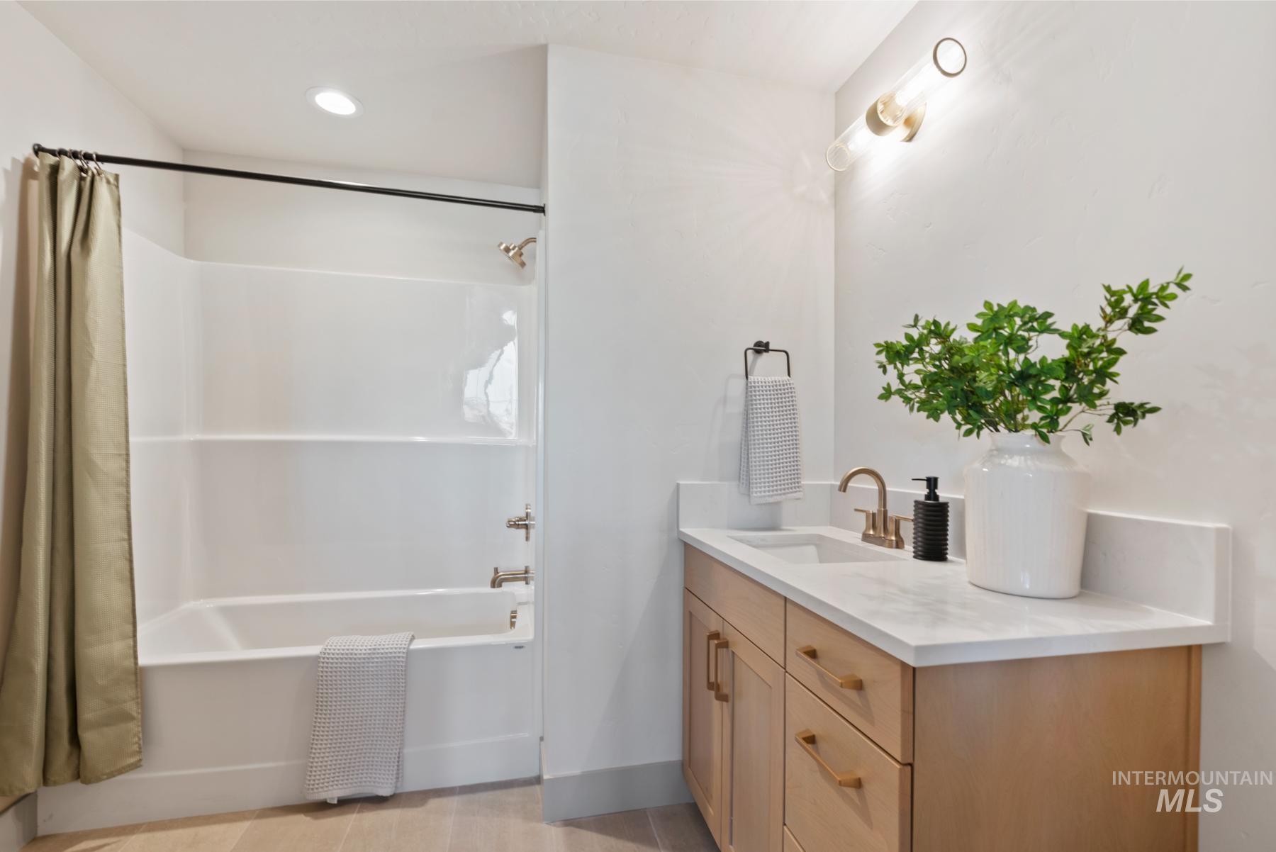Bathroom with shower / bath combination with curtain, vanity, and recessed lighting