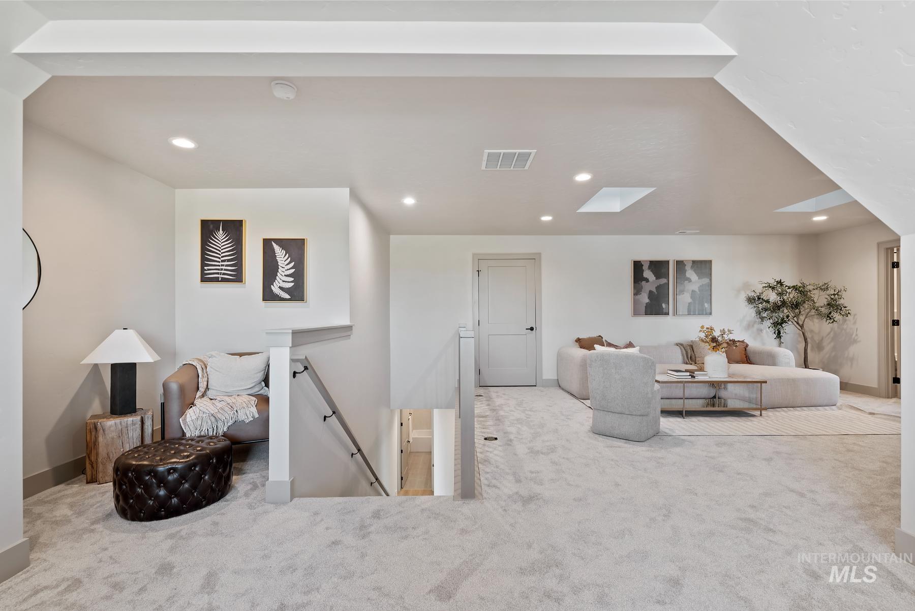 Carpeted living room featuring recessed lighting and a skylight