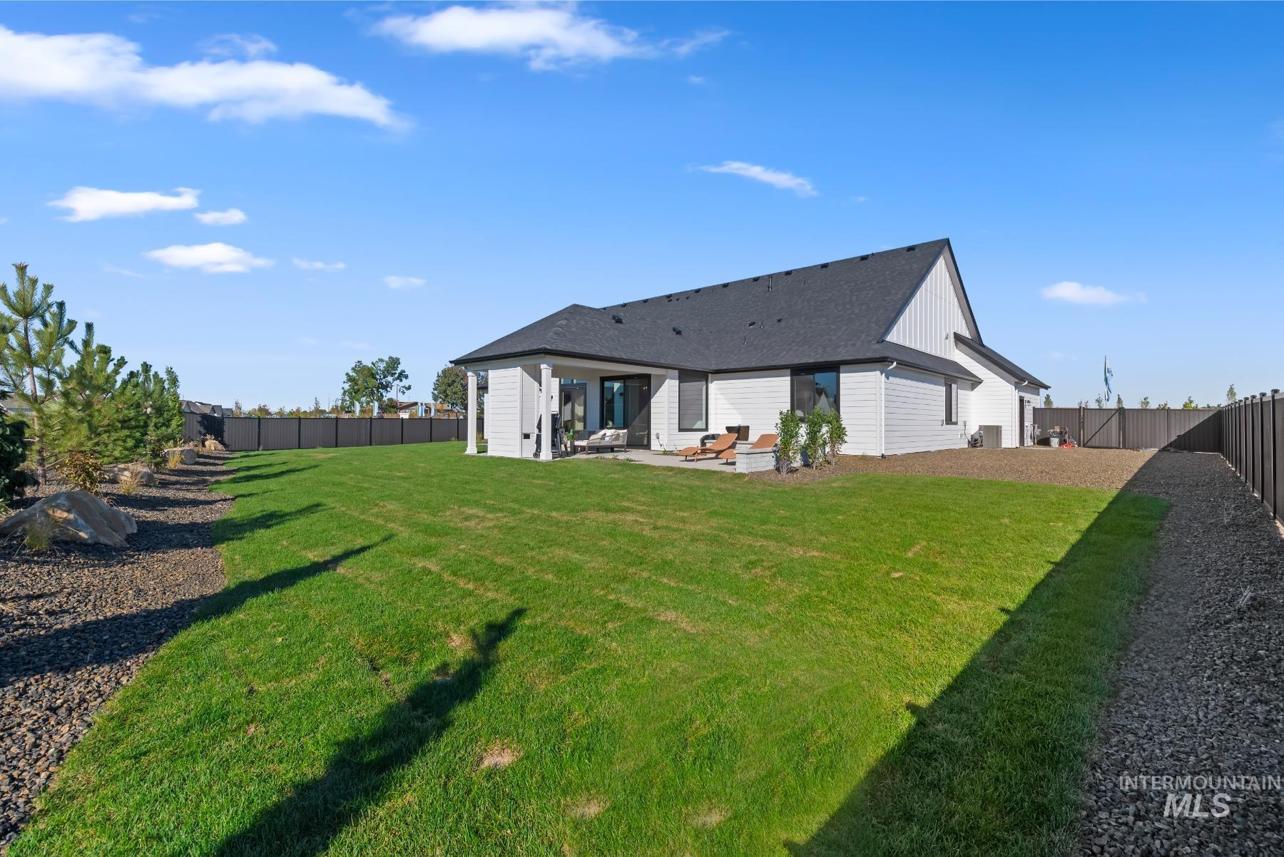 Back of house featuring a fenced backyard and a patio
