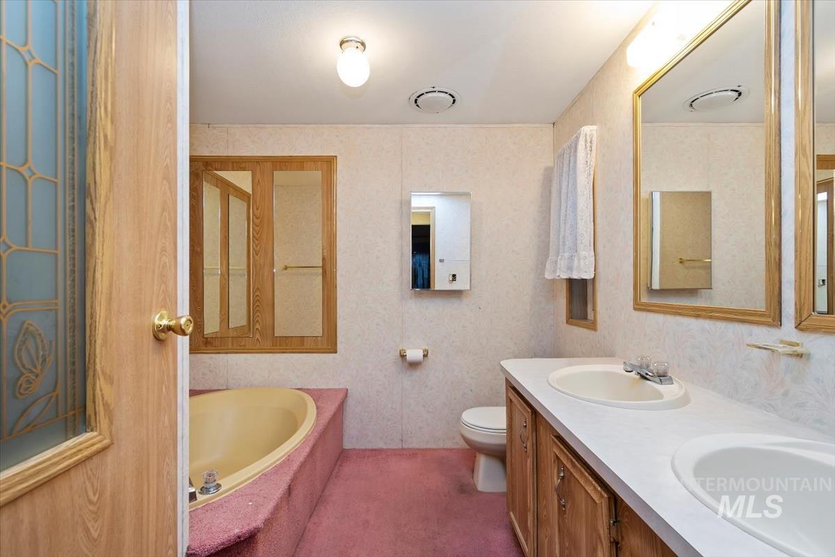 Full bath with a bath and double vanity