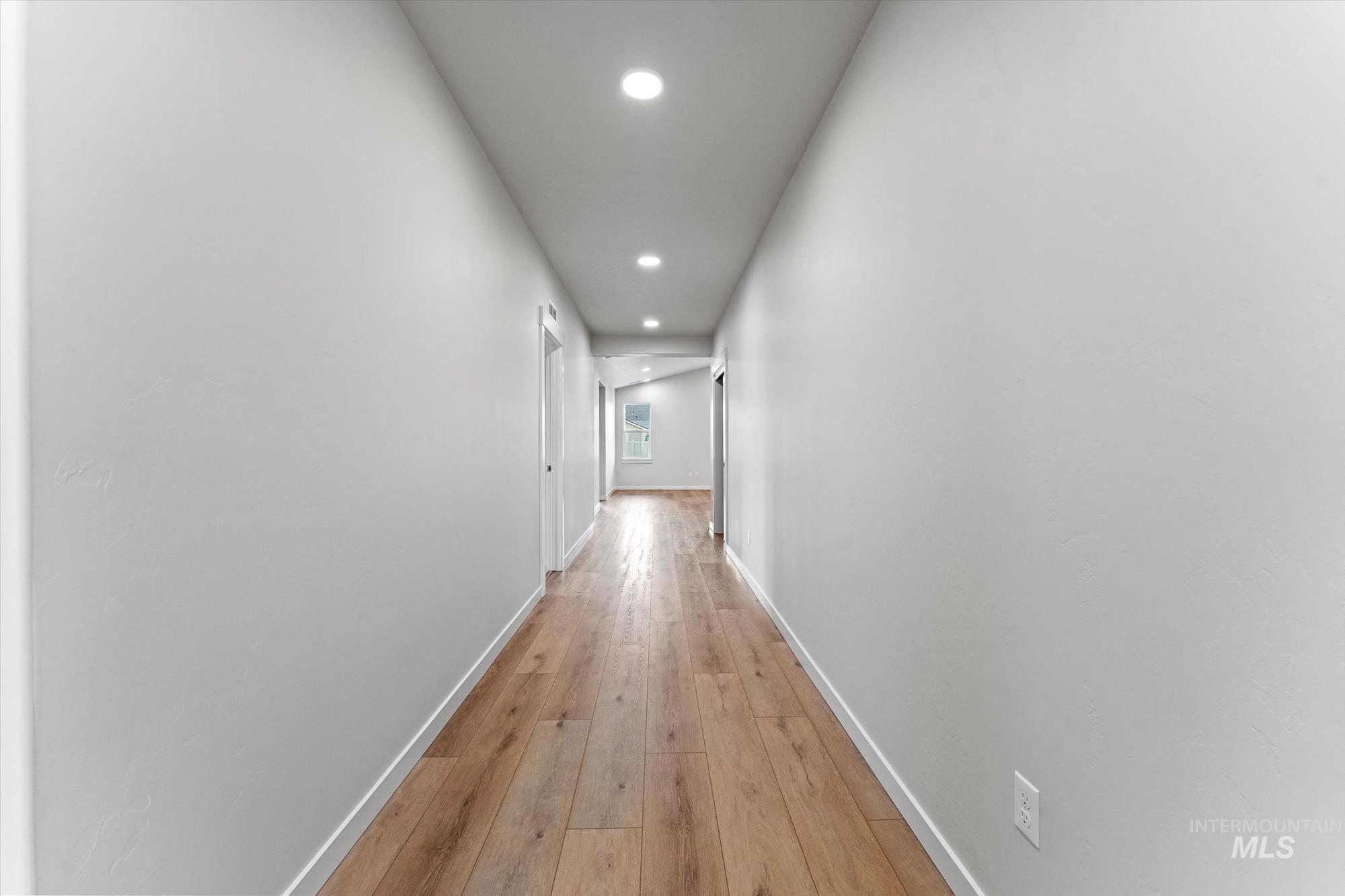 Corridor featuring recessed lighting and light wood-style floors