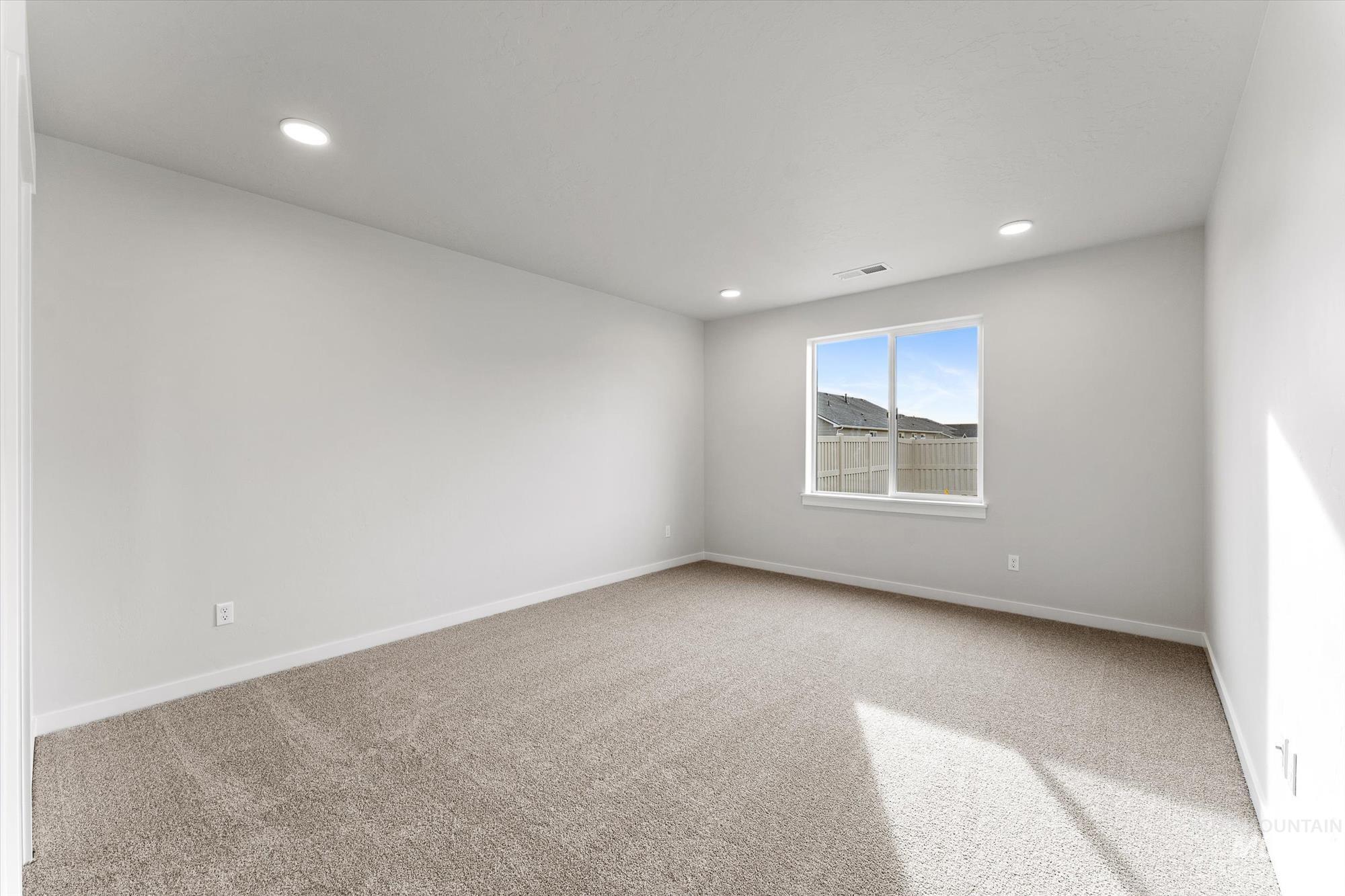 Spare room with light colored carpet and recessed lighting