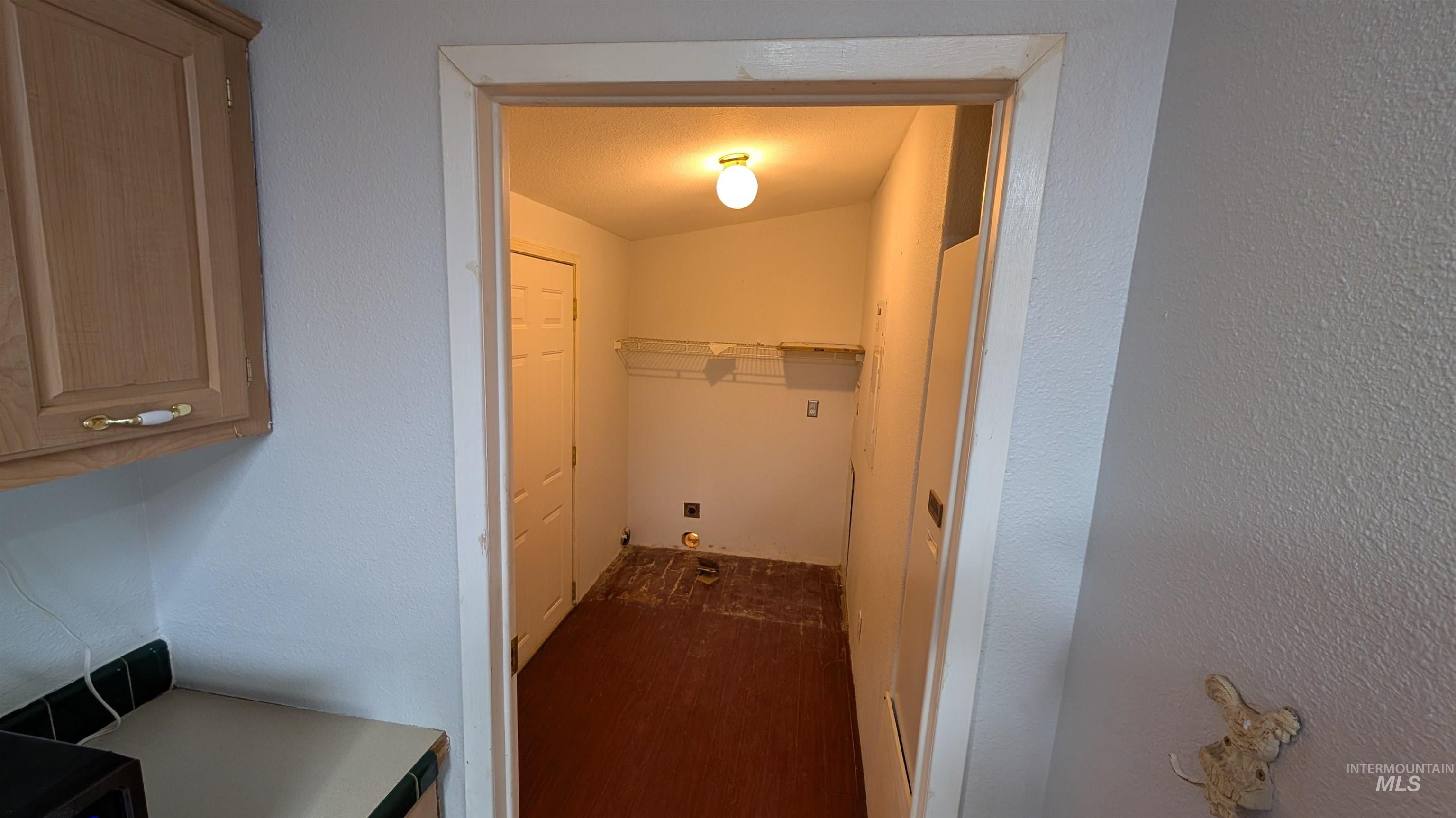 Laundry area with a textured wall