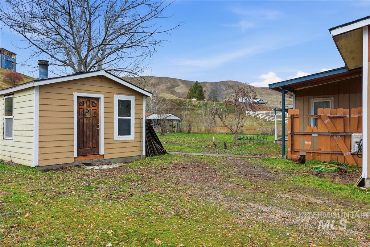 View of yard featuring a mountain view and an outbuilding