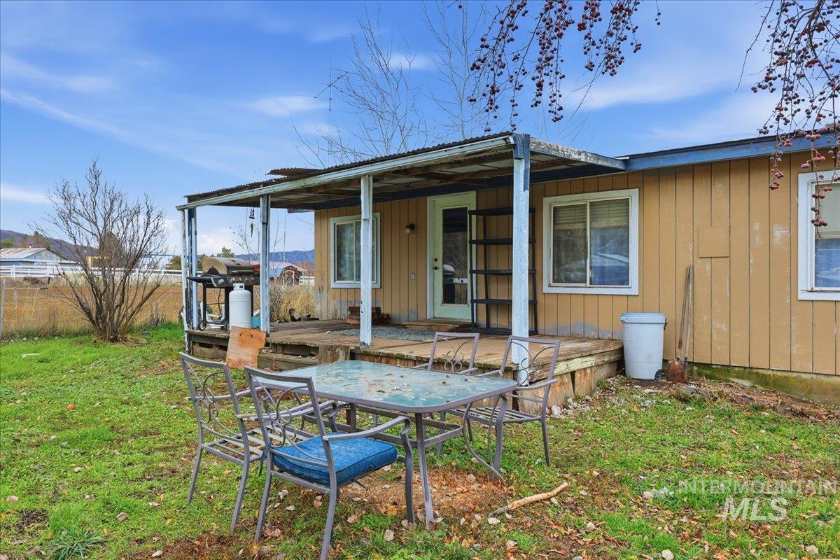 Rear view of house featuring a yard and a patio