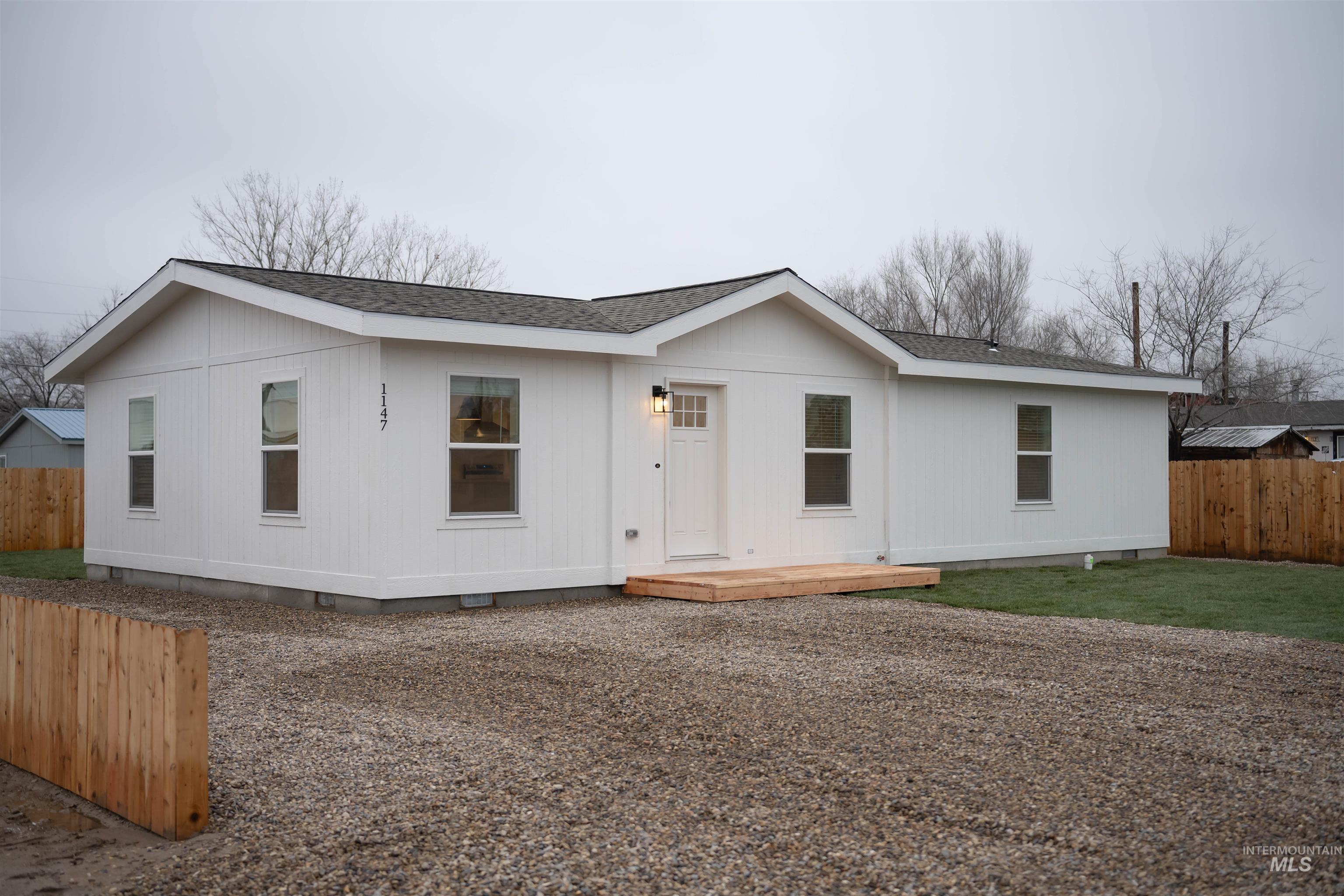 Manufactured / mobile home with crawl space, a shingled roof, and a wooden deck