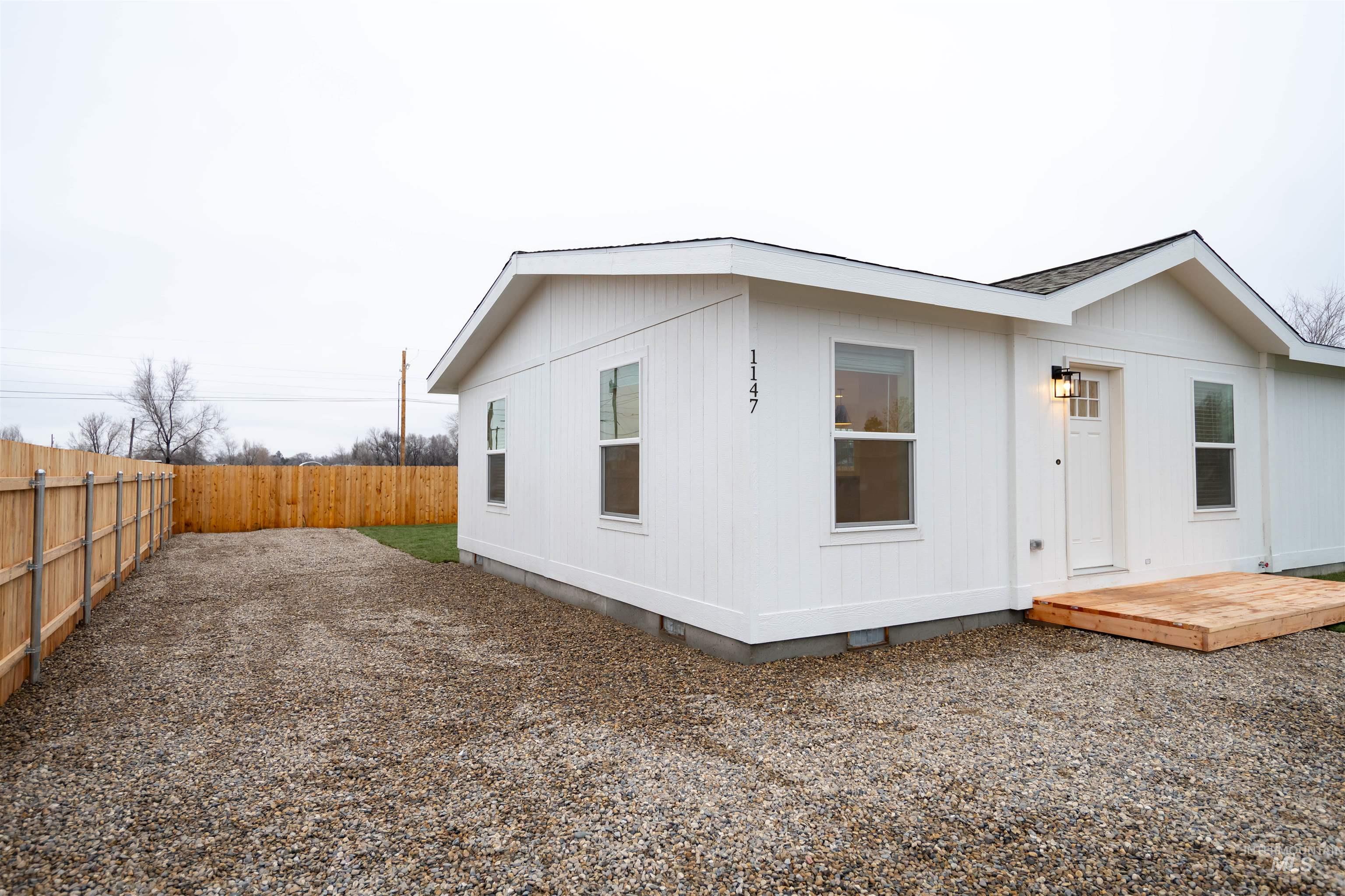 Back of property with a fenced backyard, crawl space, and a wooden deck