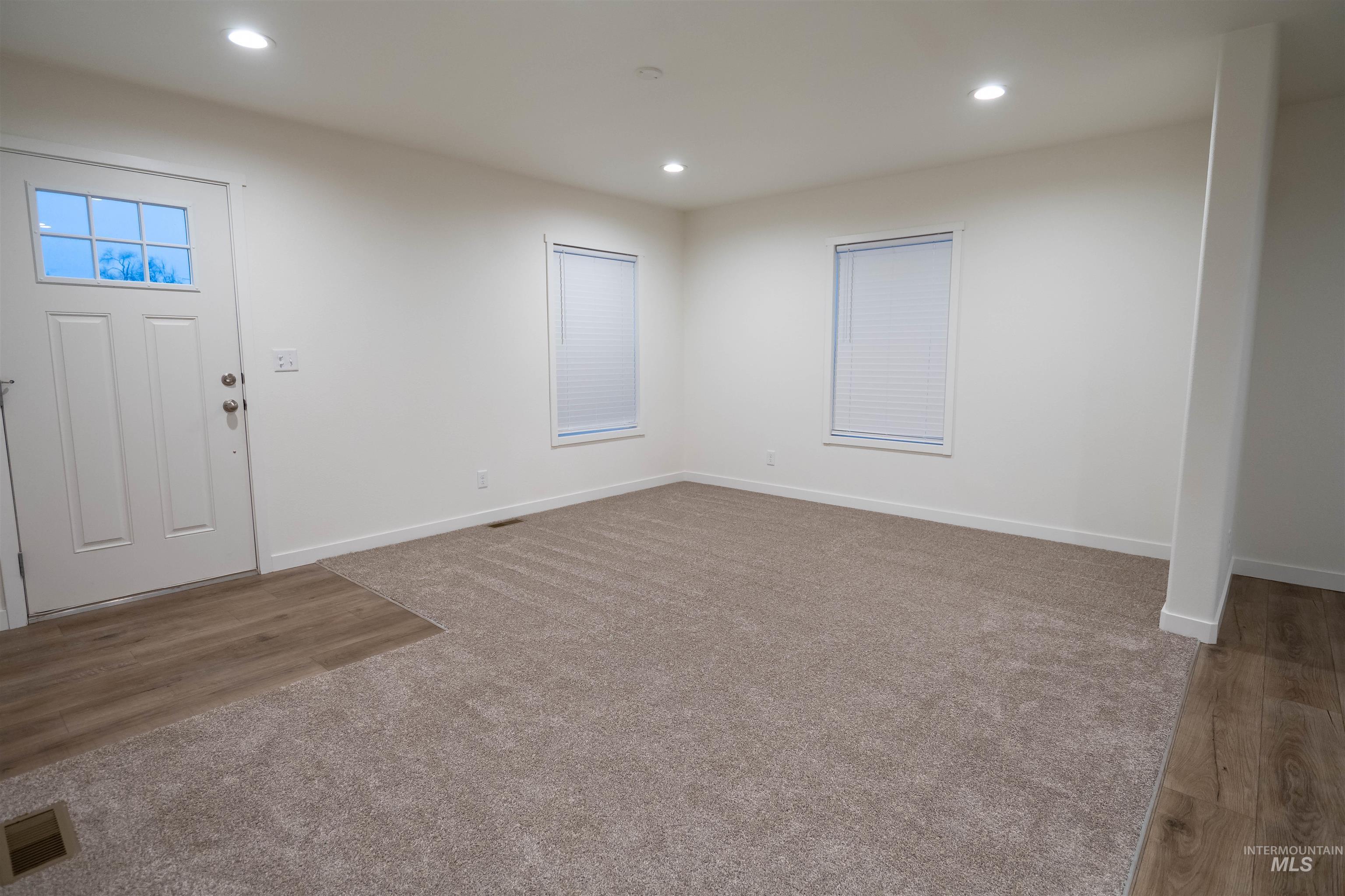 Entrance foyer with recessed lighting and light wood finished floors