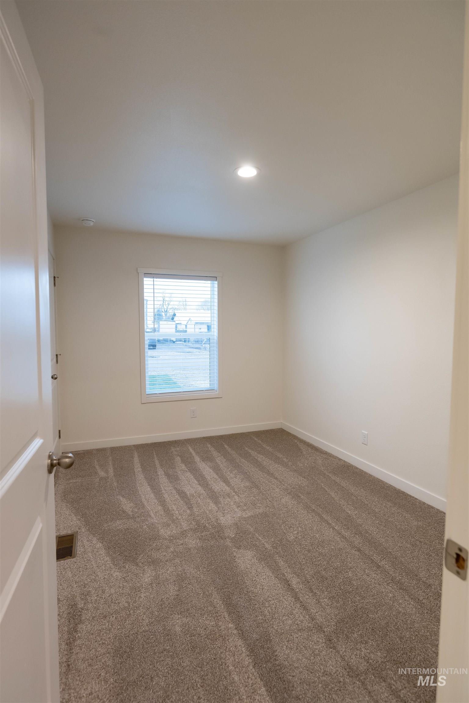 Empty room featuring carpet floors and recessed lighting