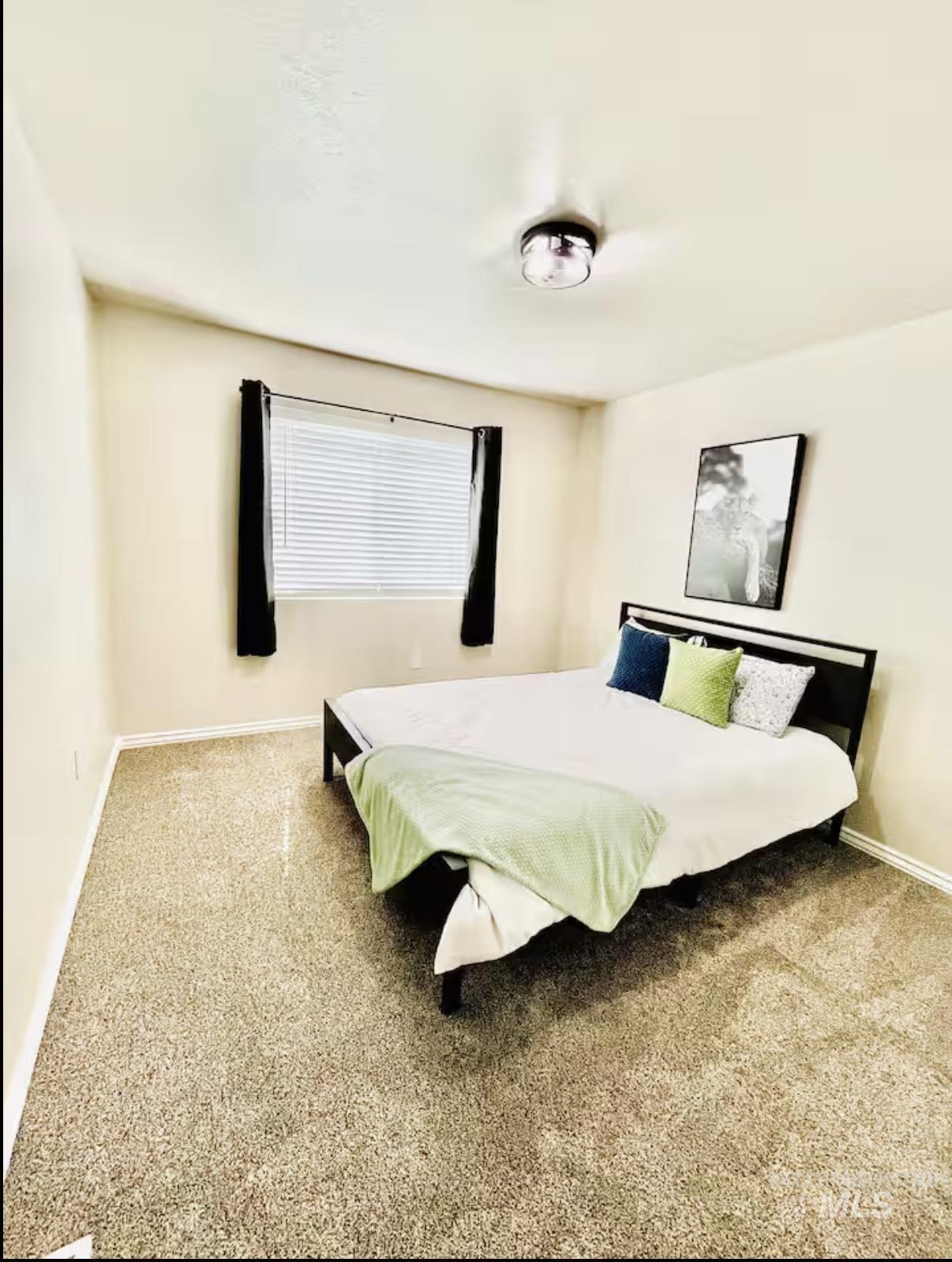 Bedroom with baseboards and carpet floors