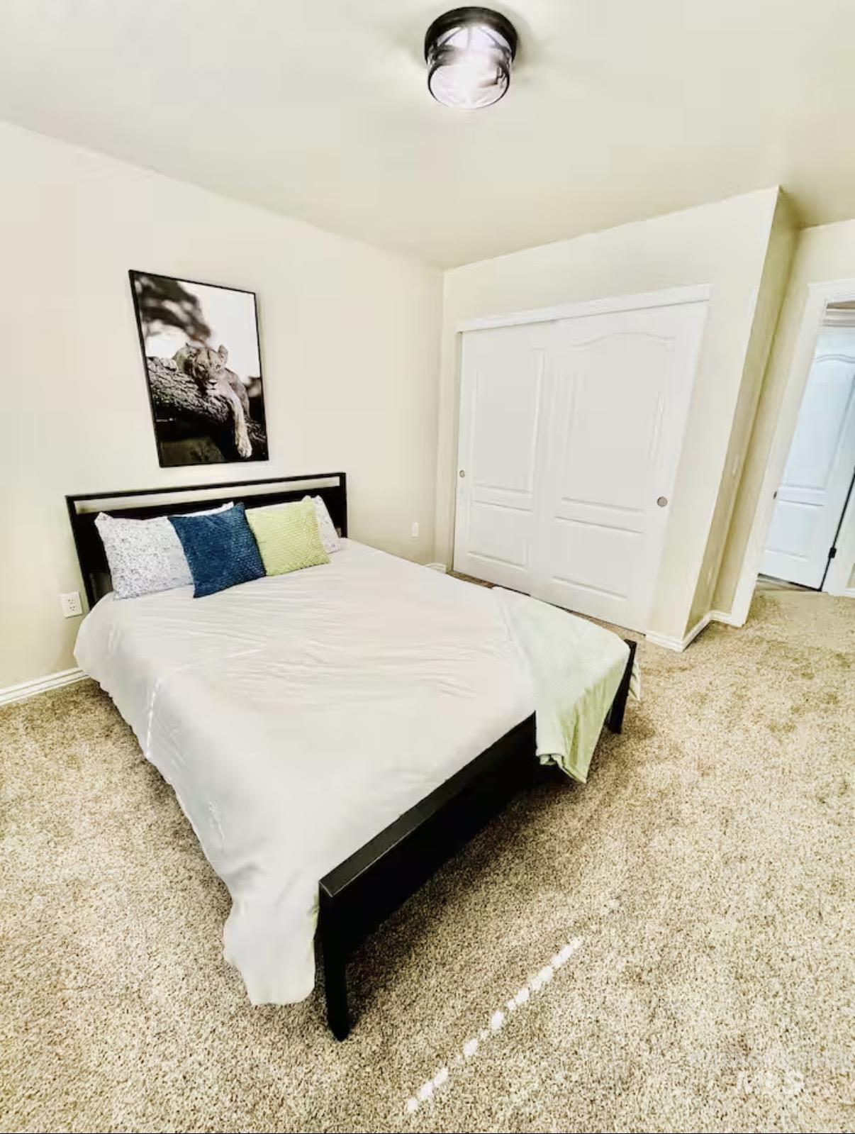 Bedroom featuring light carpet and a closet