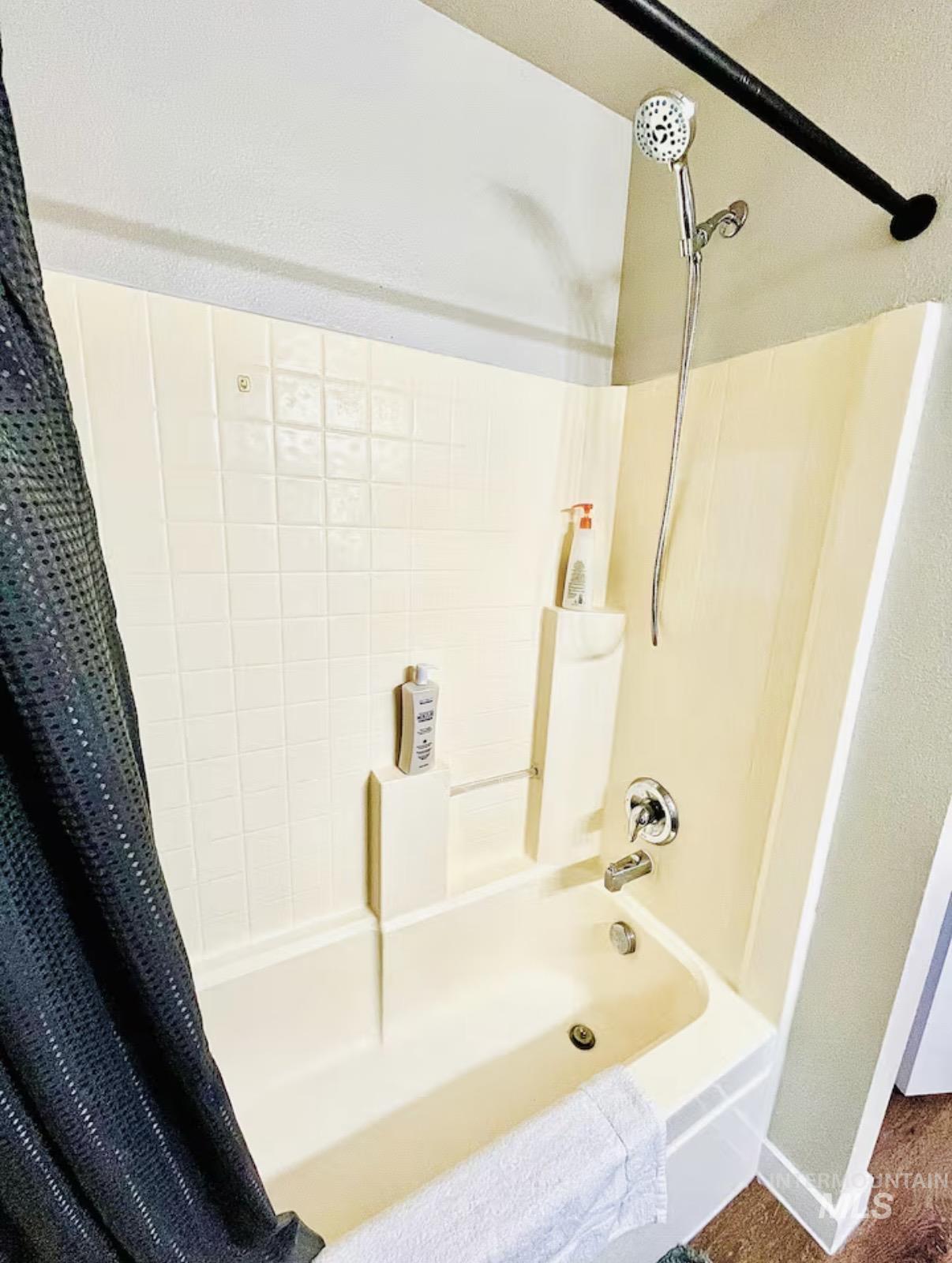 Bathroom with shower / bath combination with curtain
