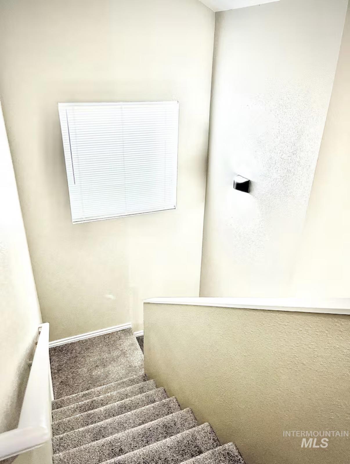 Staircase featuring carpet and baseboards