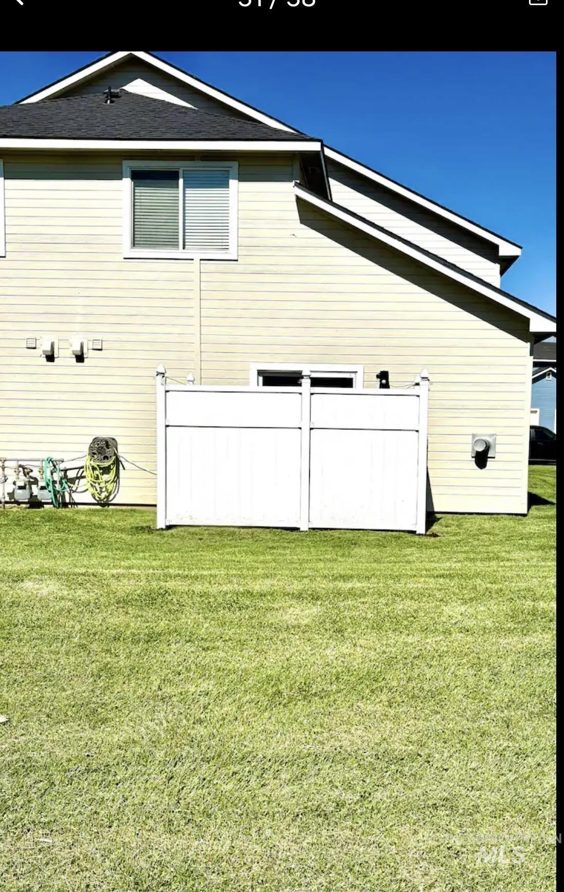 Rear view of property with a lawn