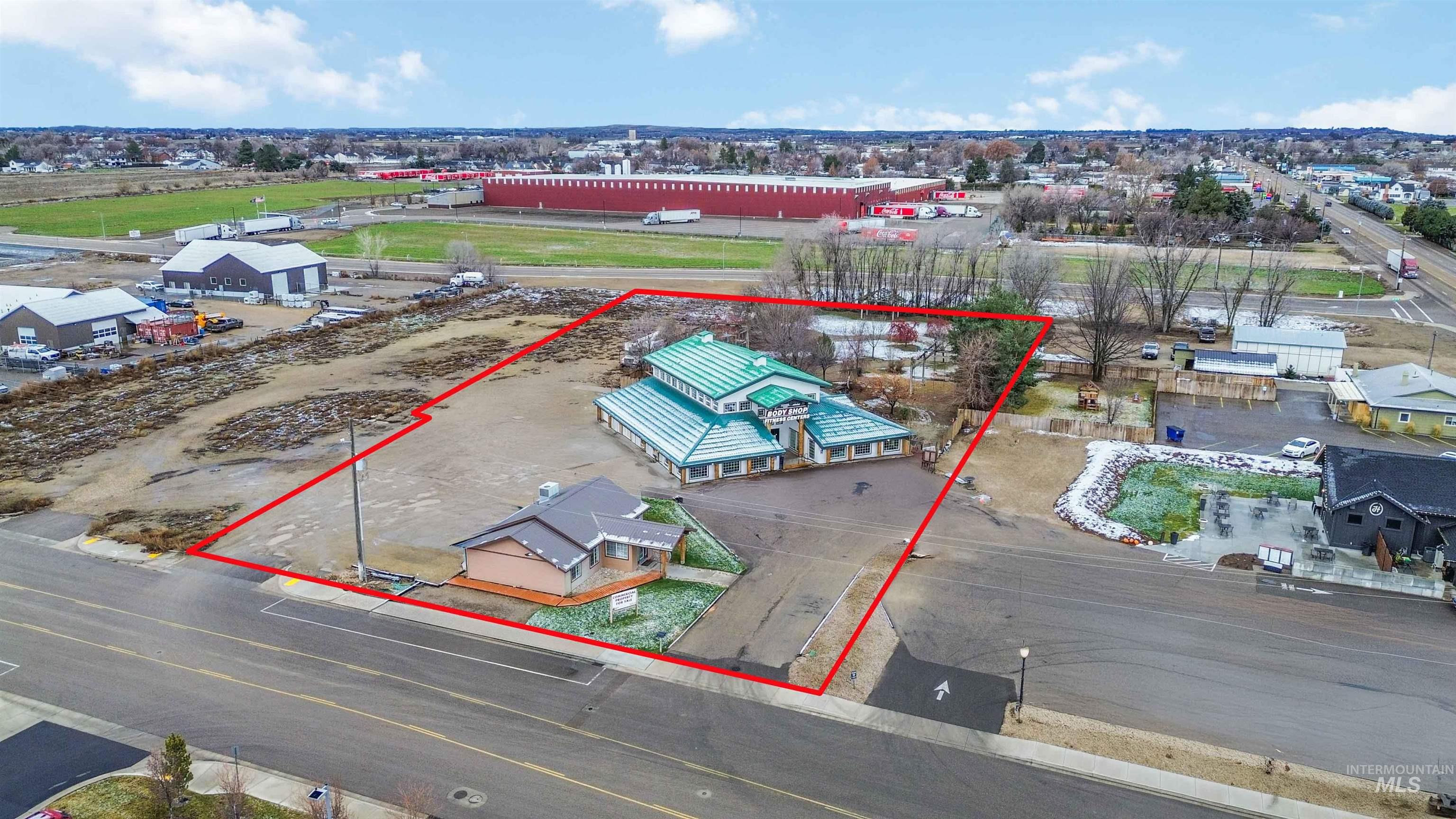 Aerial overview of property's location featuring industrial structures and property parcel outlined