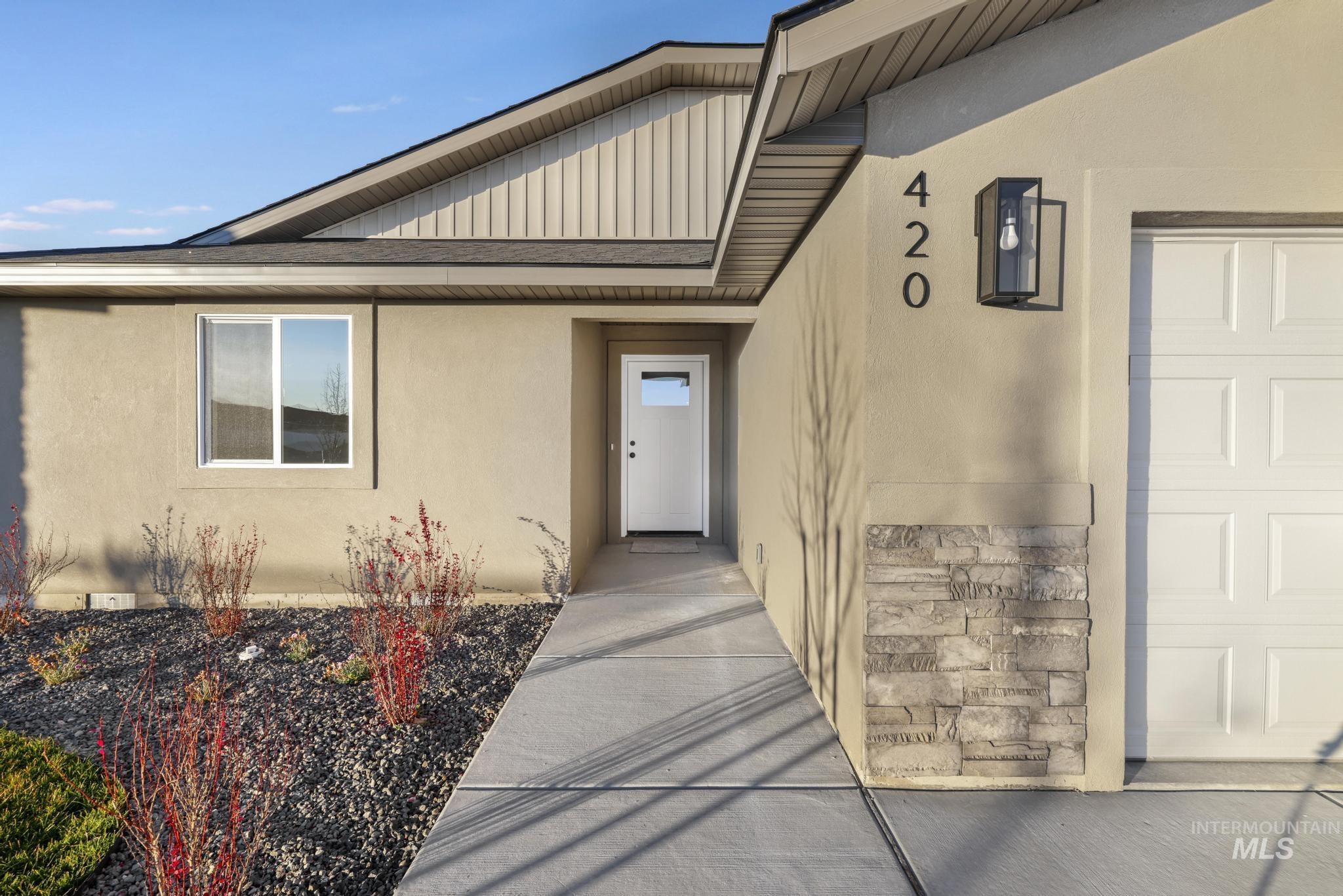 View of exterior entry with stucco siding