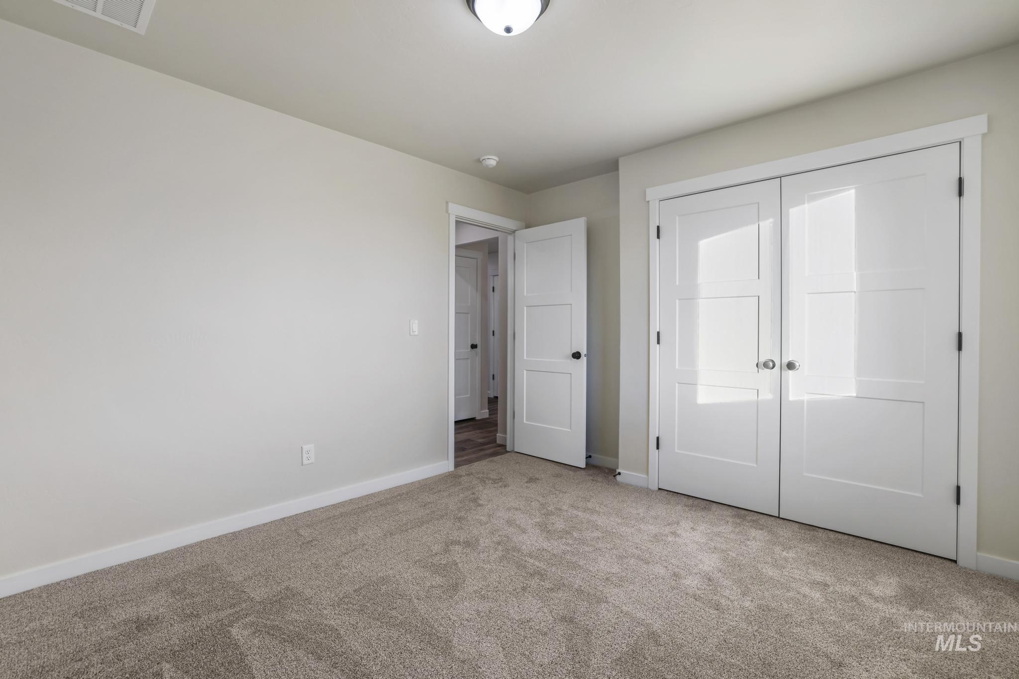 Unfurnished bedroom featuring carpet flooring and a closet