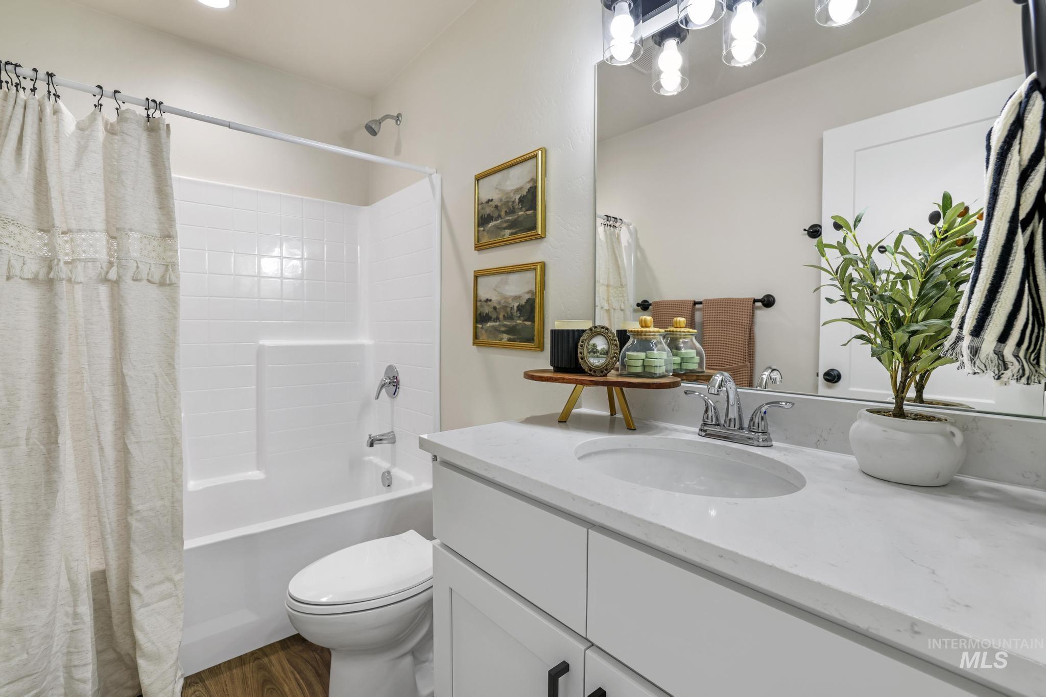 Full bath with shower / bath combo with shower curtain and vanity