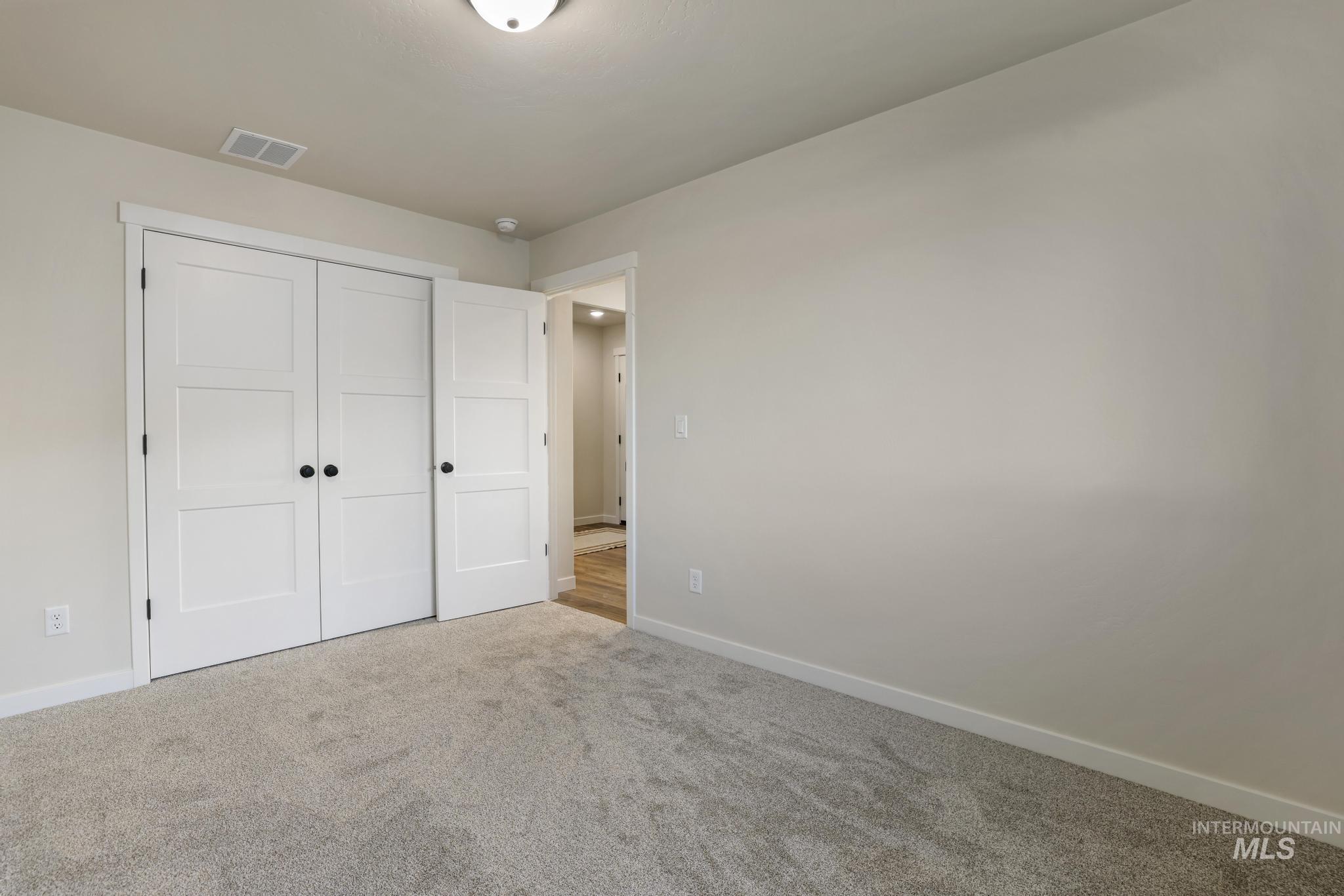 Unfurnished bedroom featuring carpet and a closet