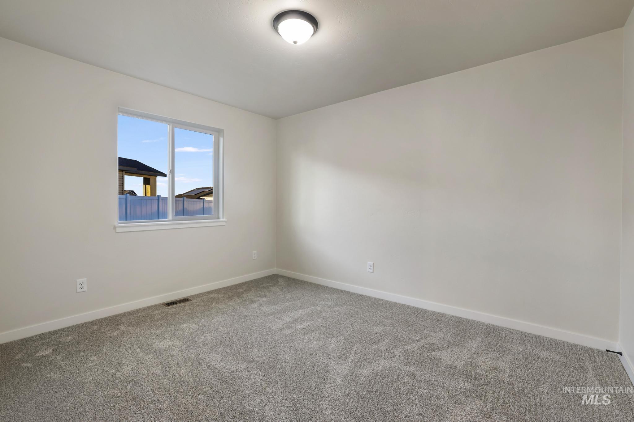 Unfurnished room featuring baseboards and carpet floors