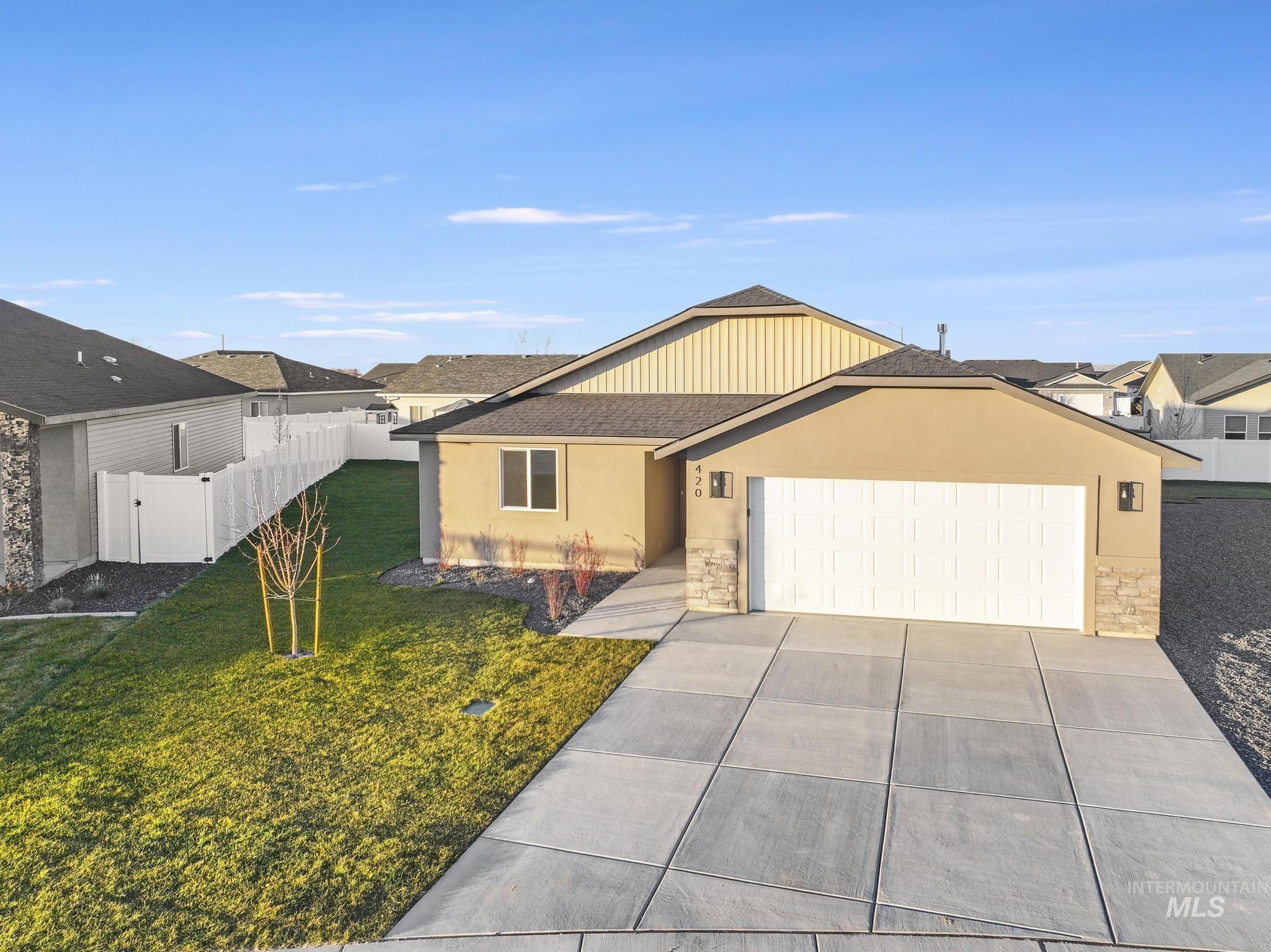 Ranch-style home featuring a garage, stucco siding, stone siding, concrete driveway, and a residential view