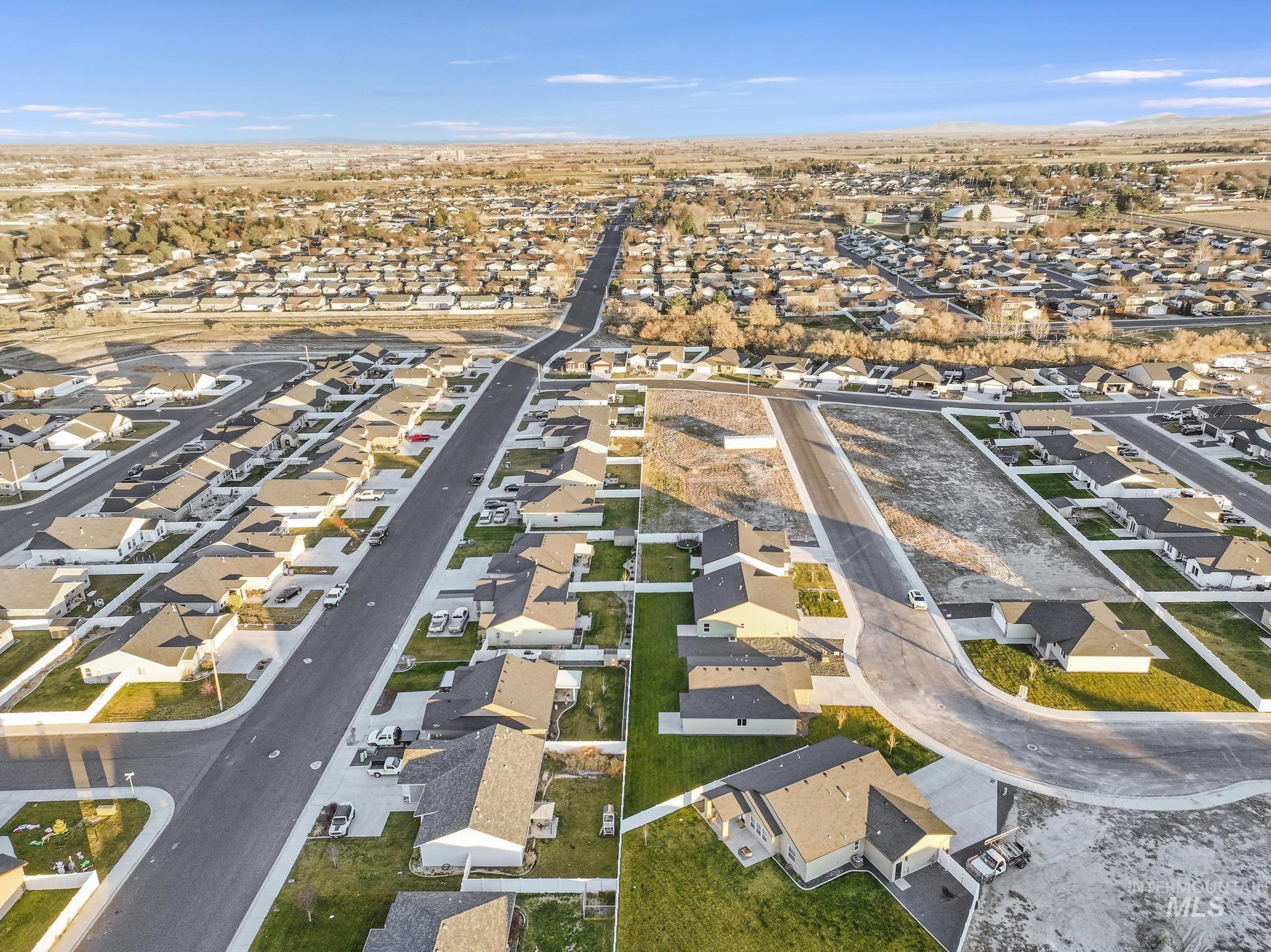 Aerial view of property's location featuring nearby suburban area