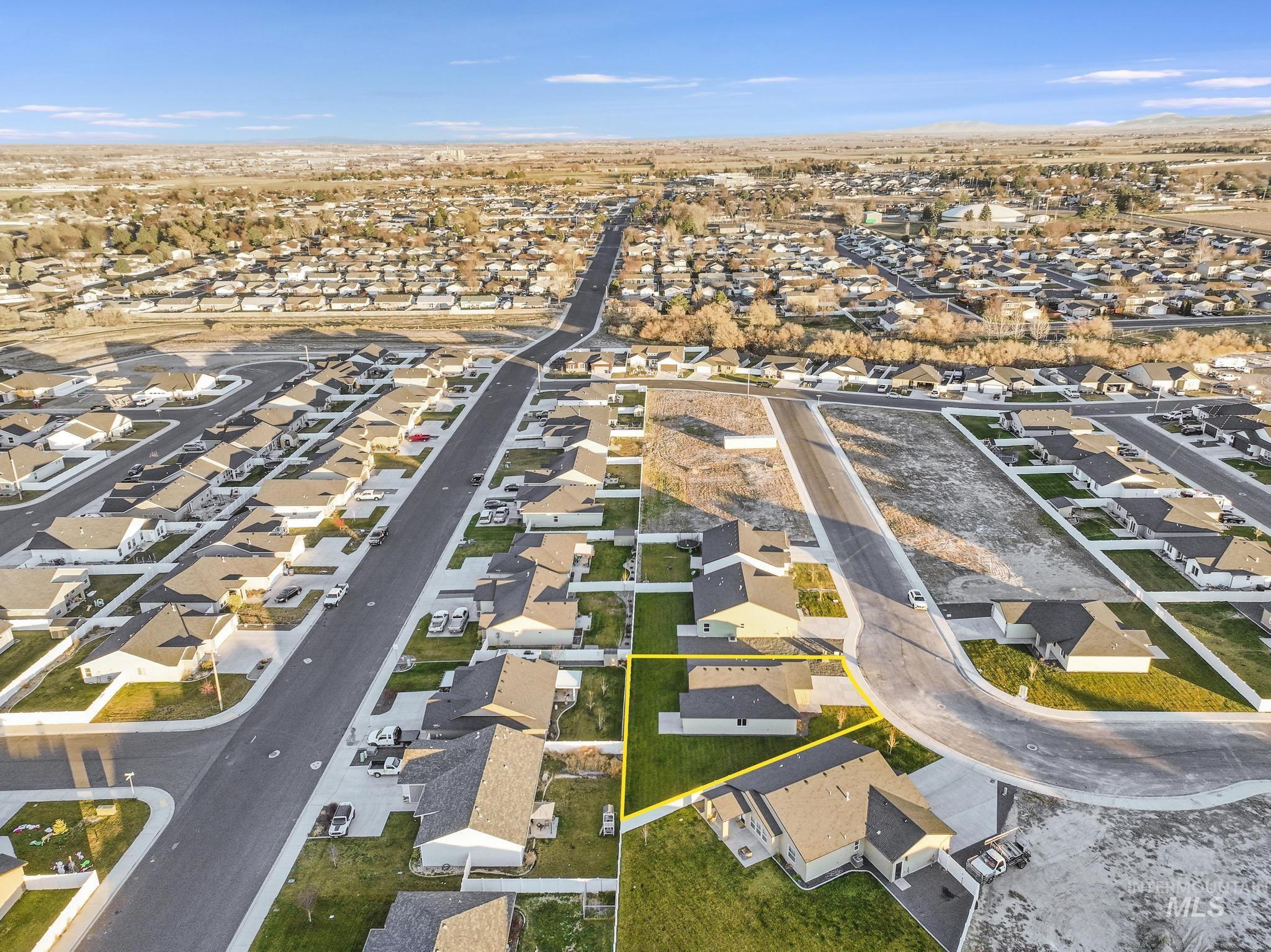 Aerial view of property's location featuring nearby suburban area and property parcel outlined