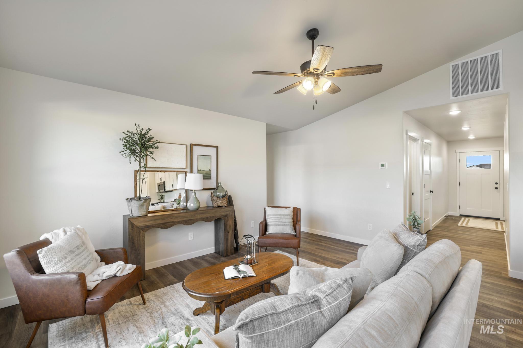 Living room with vaulted ceiling, ceiling fan, dark wood-style floors, and recessed lighting