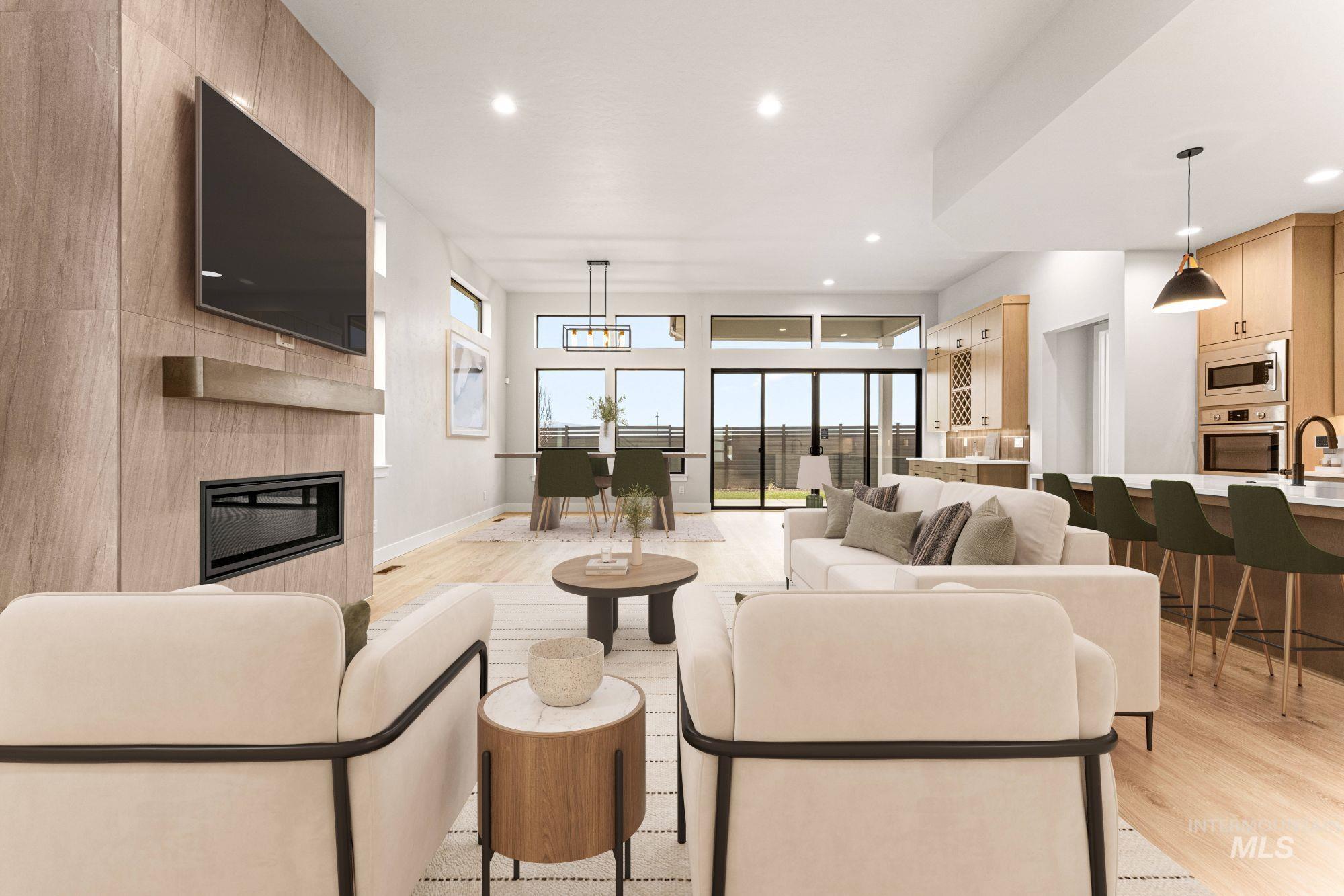 Living area with light wood-style flooring, a large fireplace, and recessed lighting