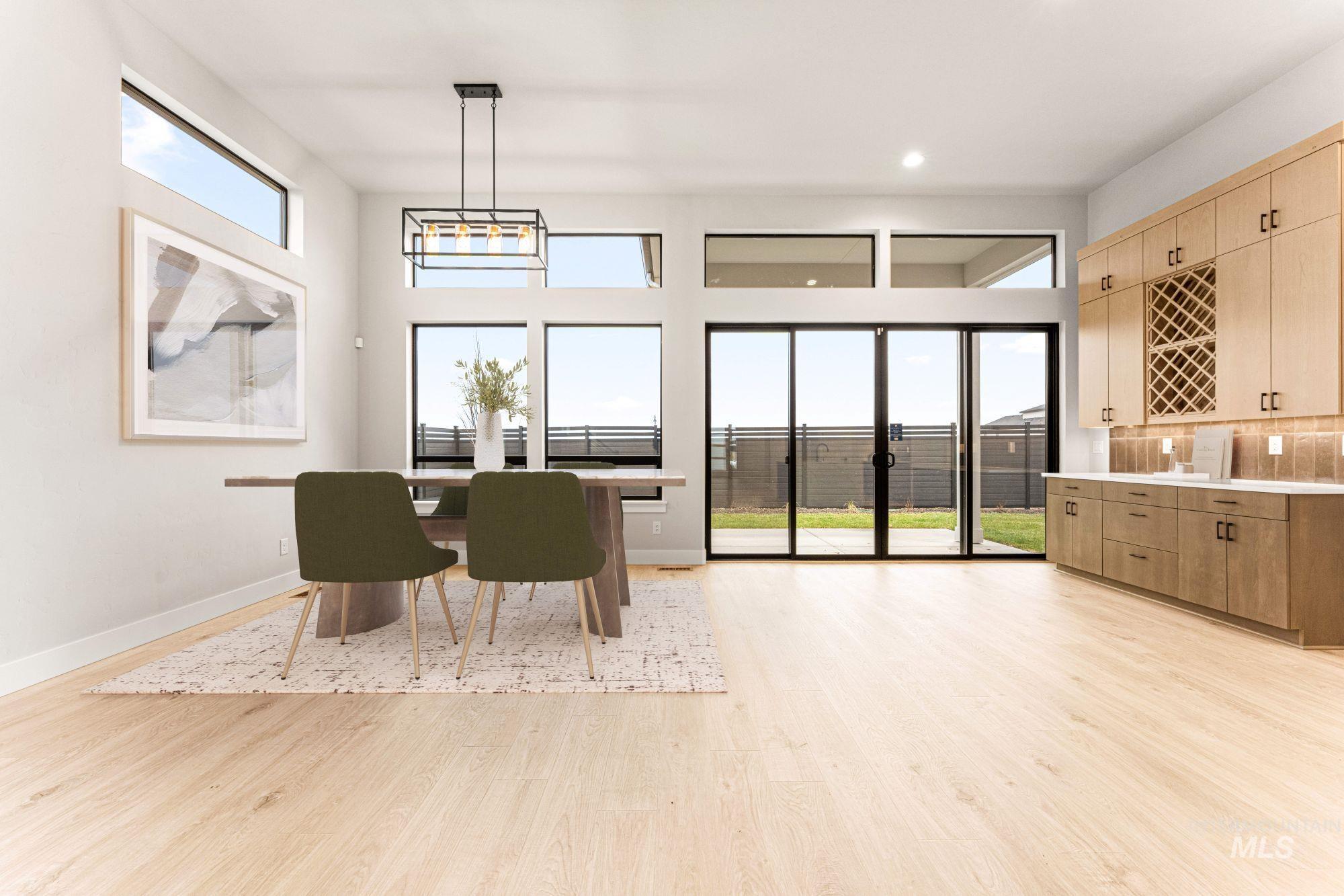 Dining area with light wood-style flooring and recessed lighting