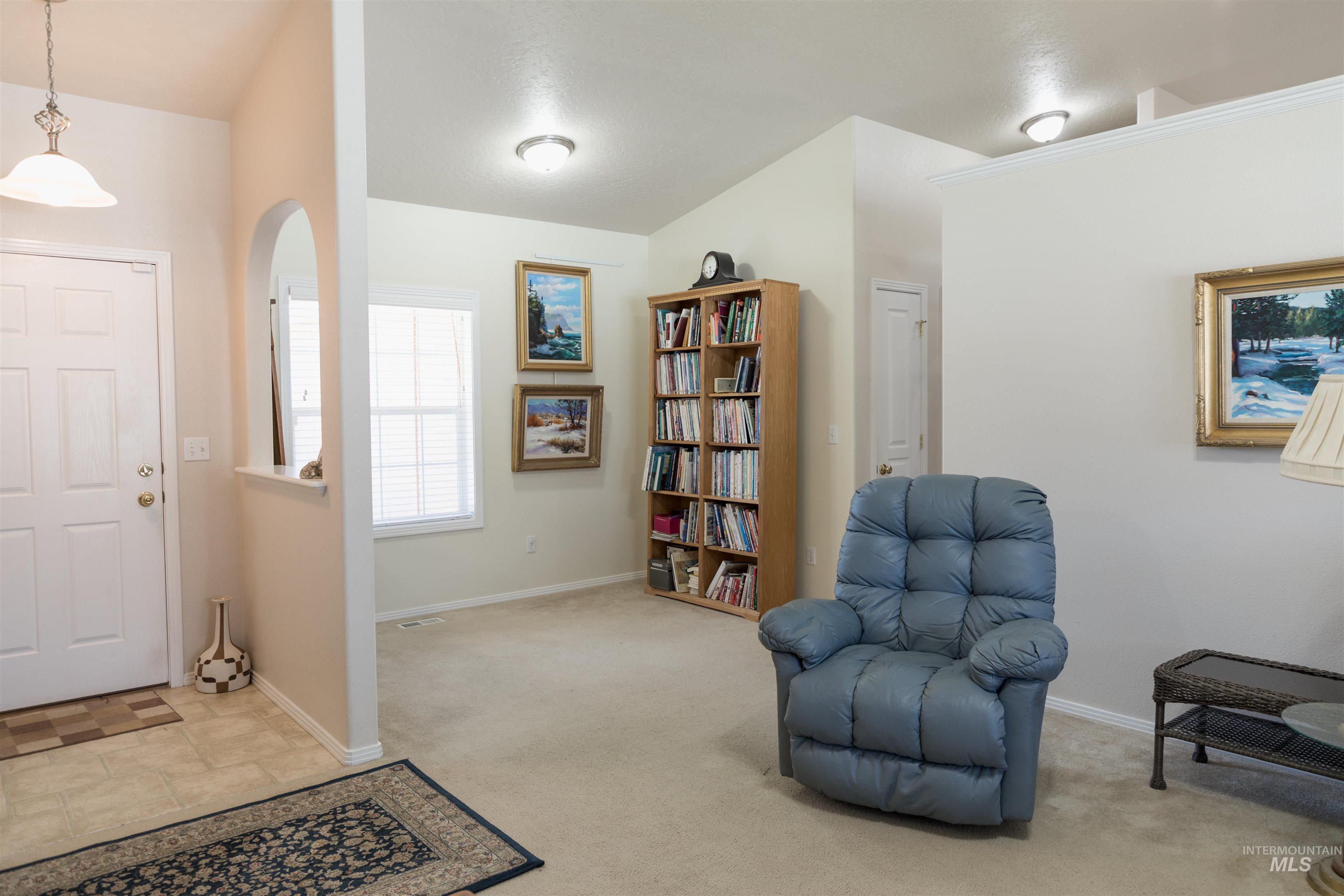 Entryway with carpet flooring and stone finish floors