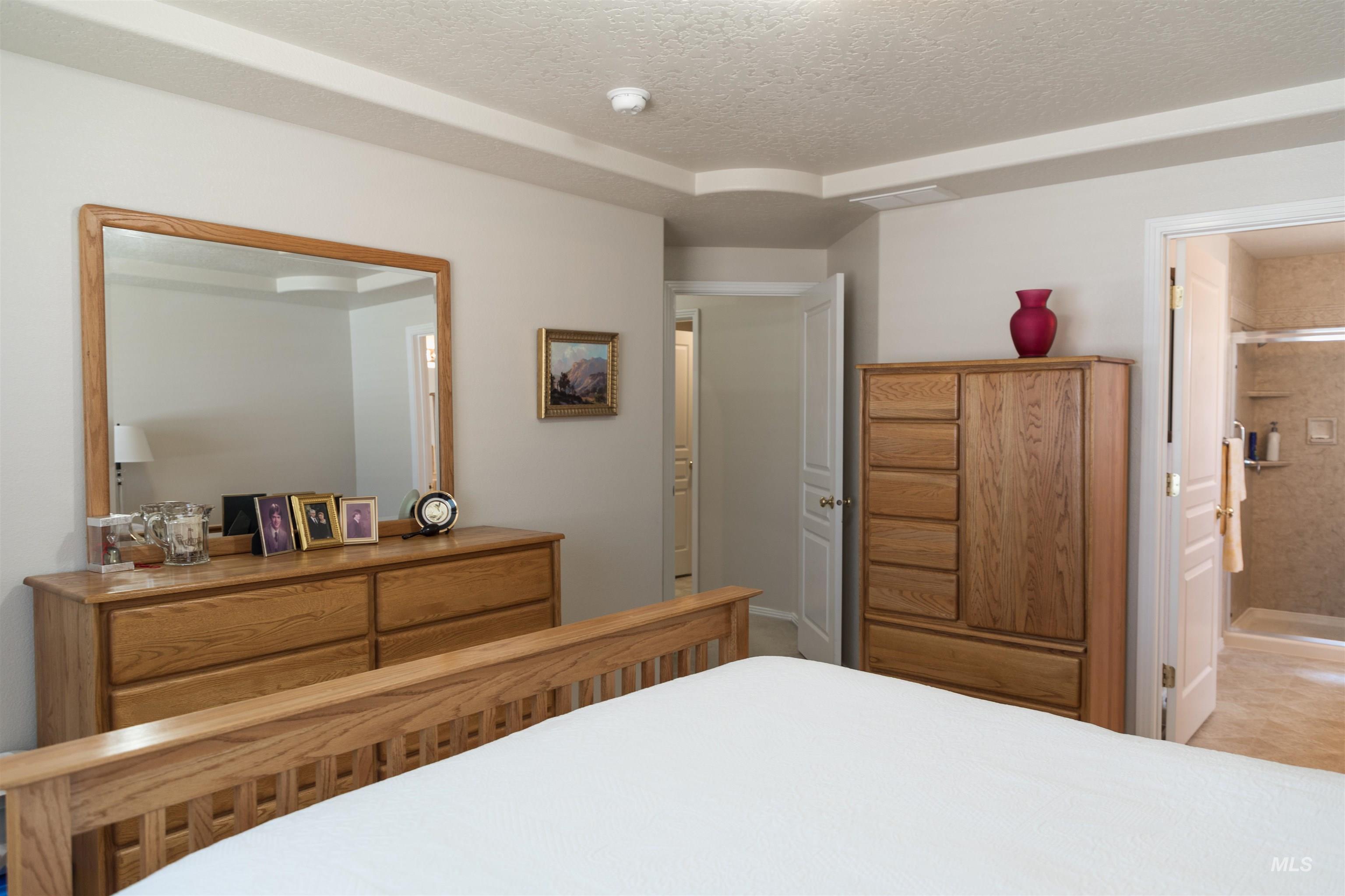 Bedroom featuring a textured ceiling and ensuite bathroom