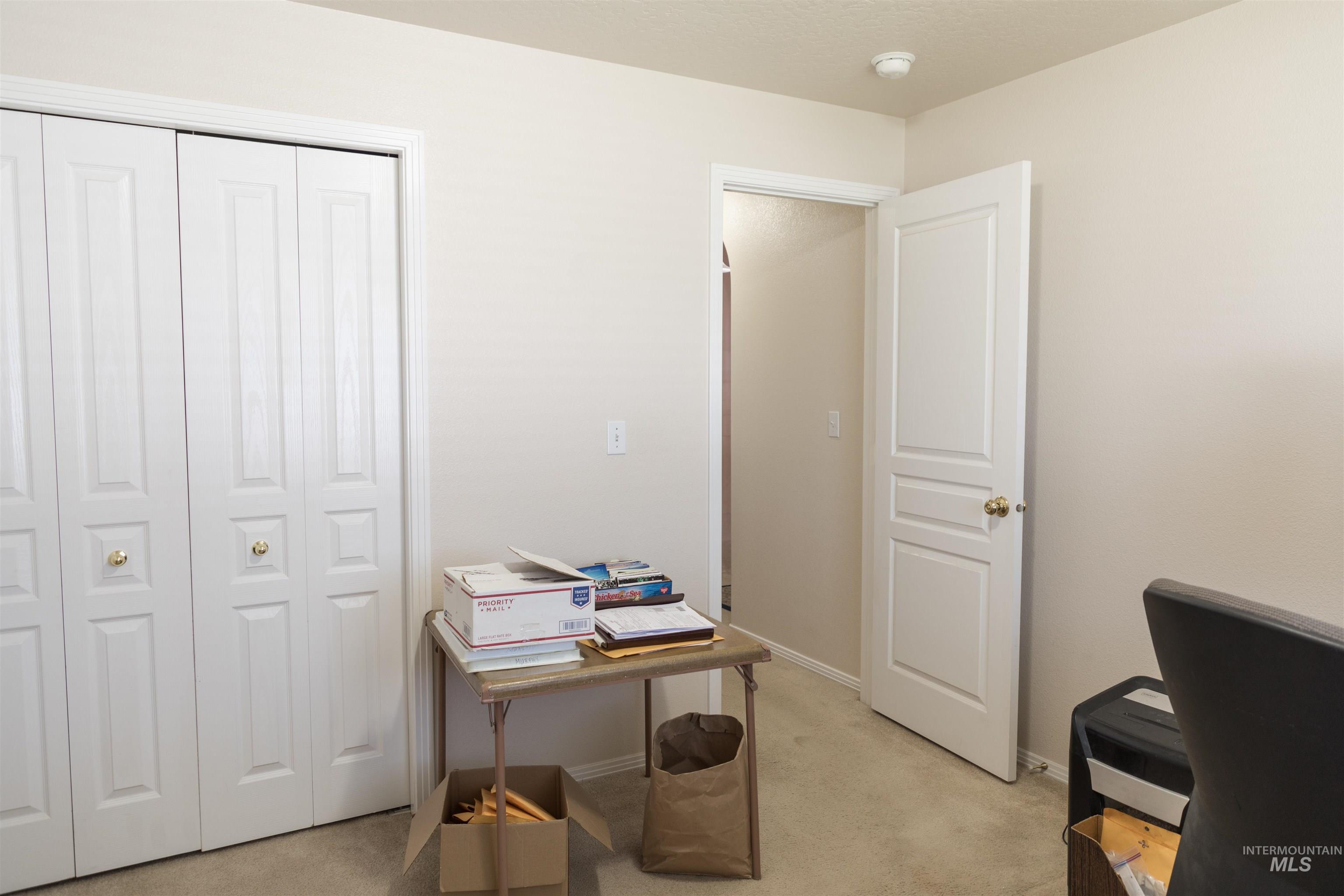 Office area with light carpet and baseboards