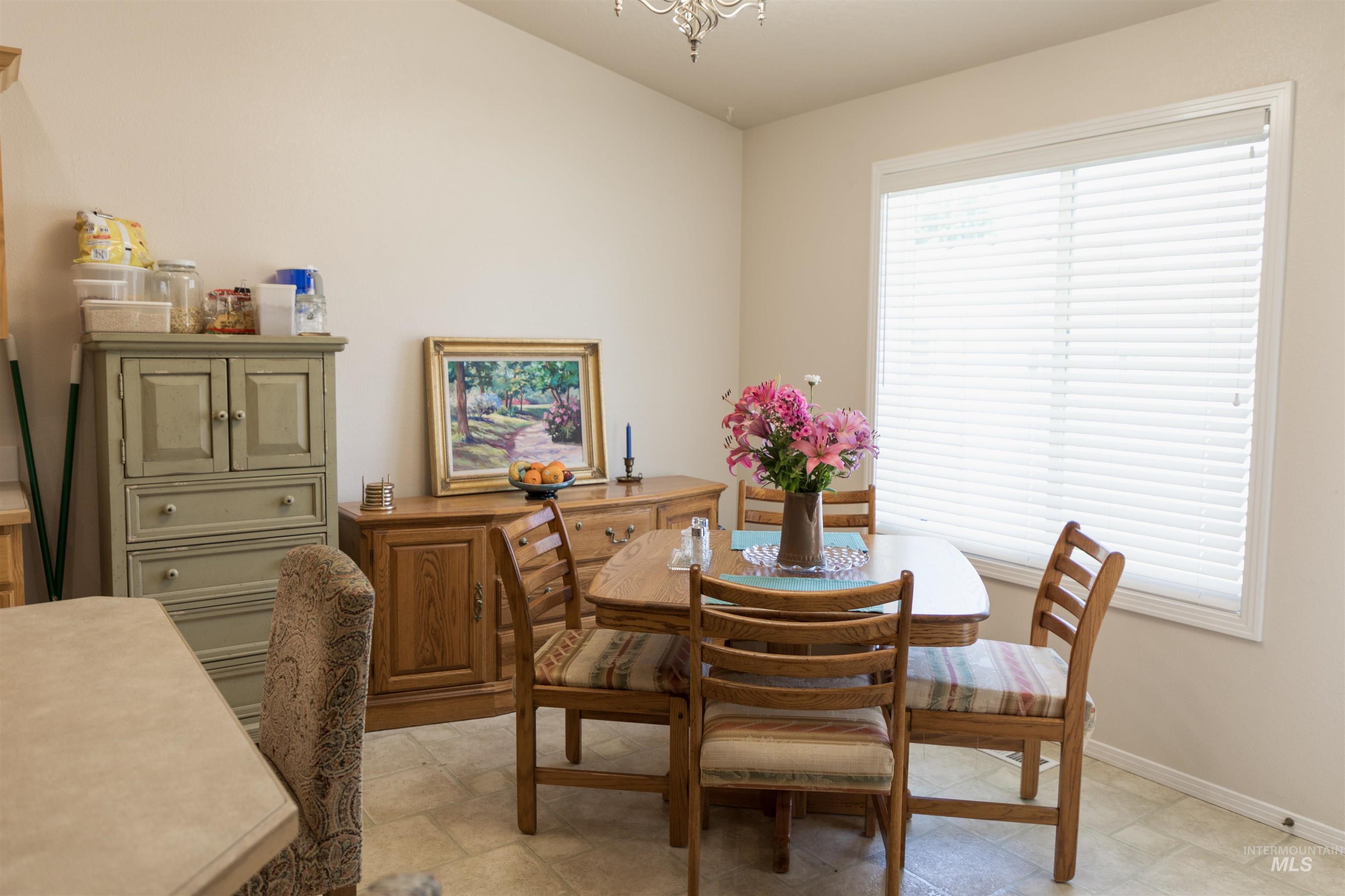 Dining space with a chandelier and baseboards