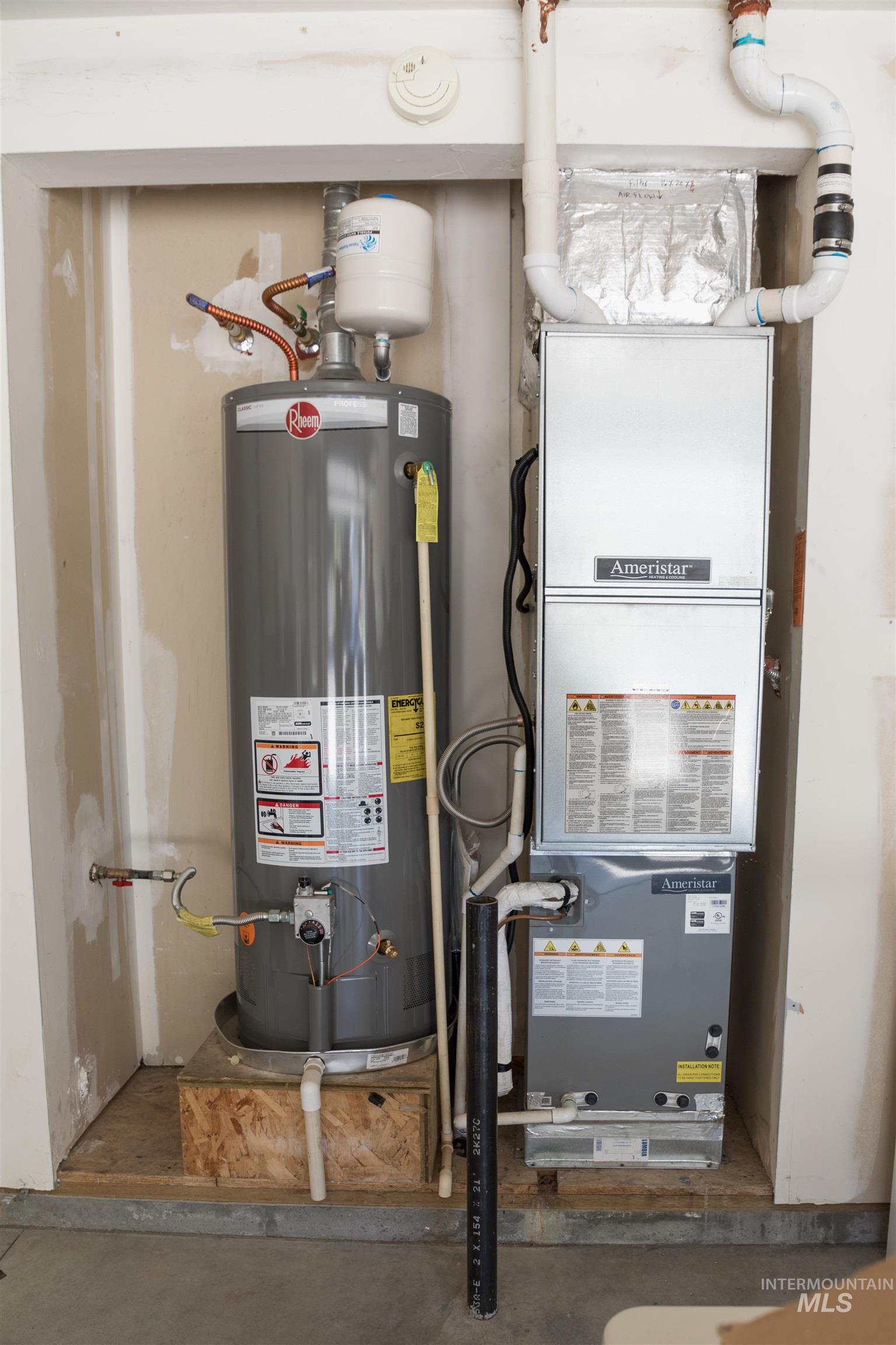 Utility room with gas water heater and heating unit