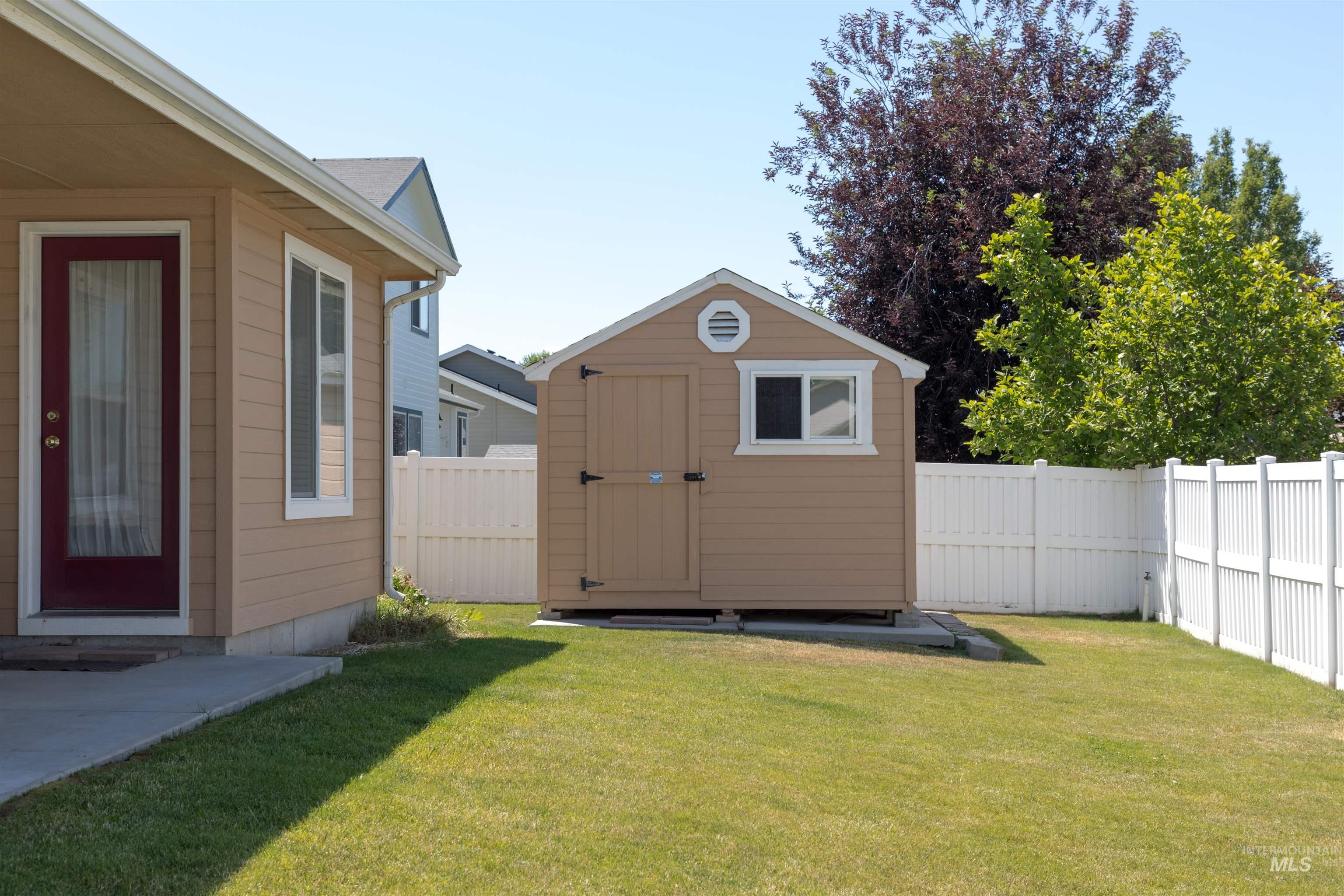View of shed with a fenced backyard