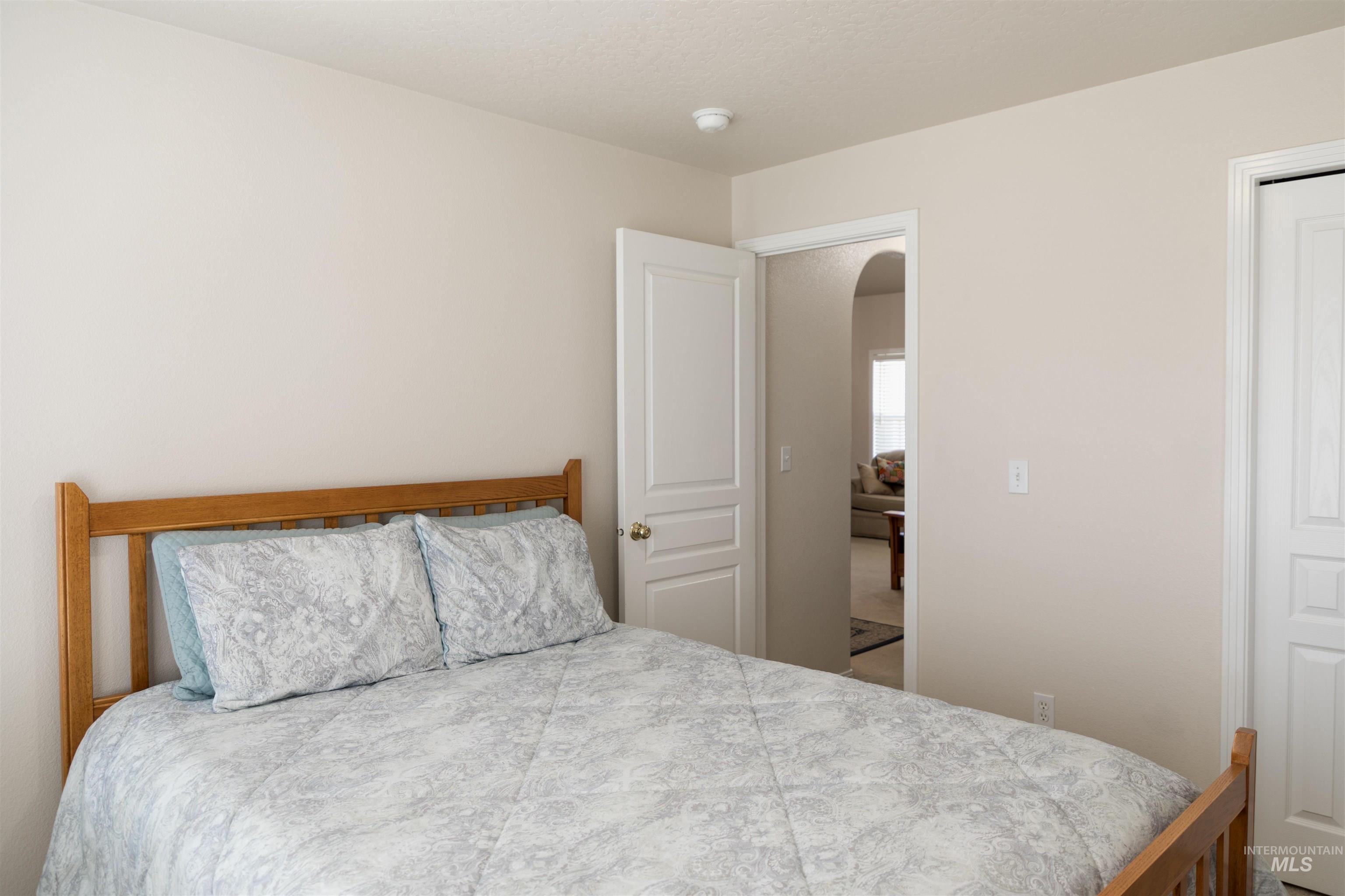 Bedroom featuring arched walkways