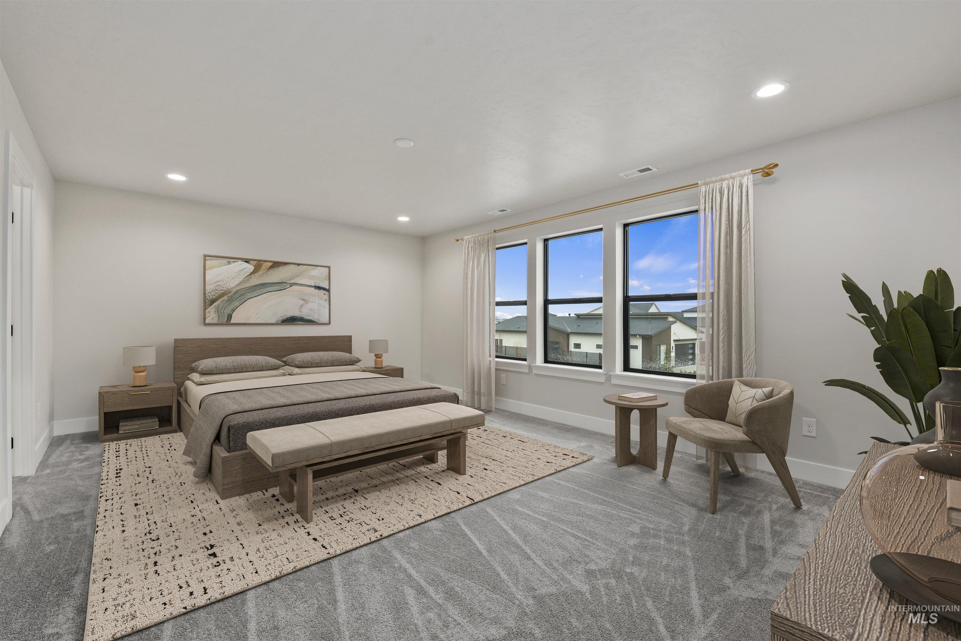 Bedroom with light colored carpet and recessed lighting