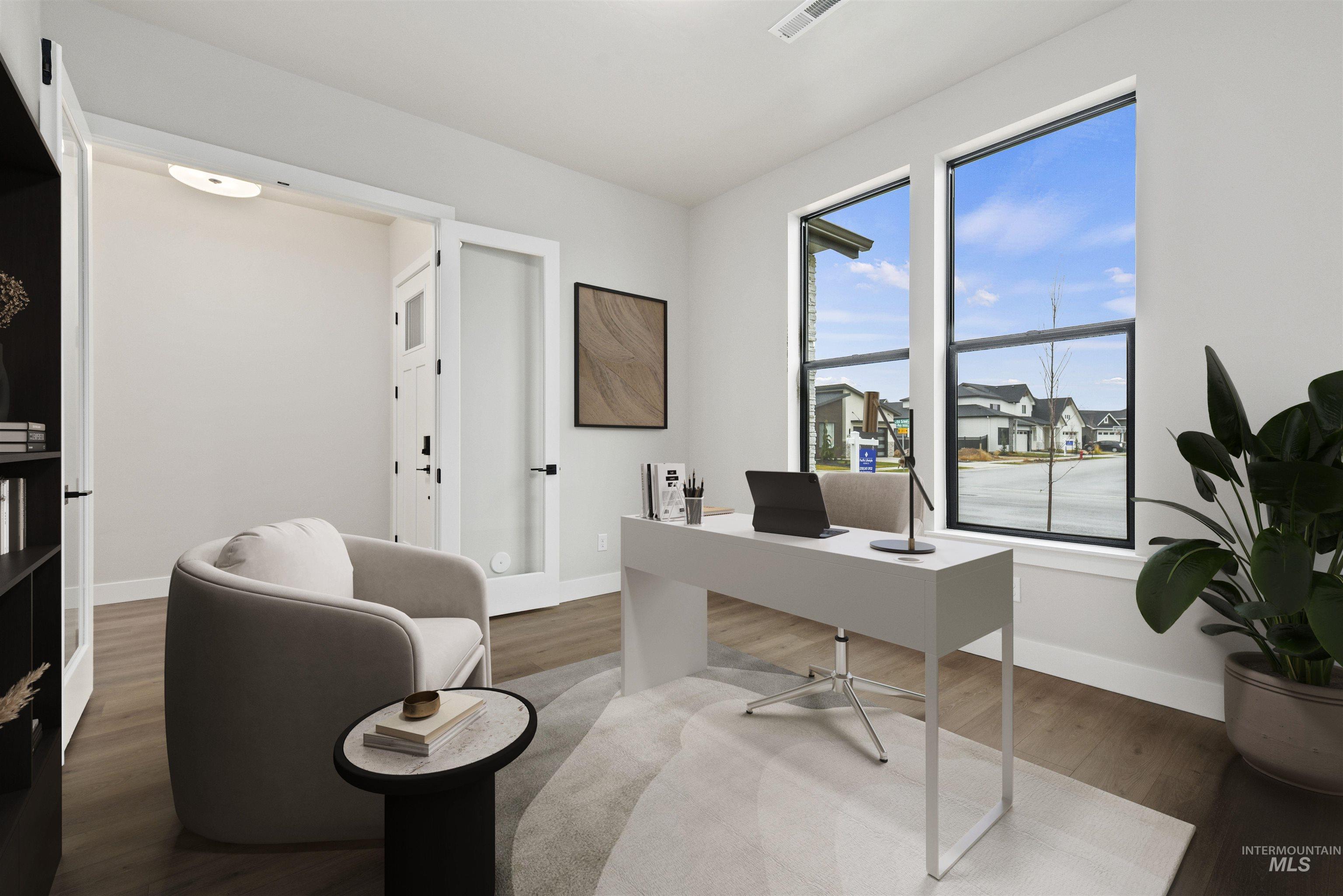 Office area featuring wood finished floors, french doors, and a residential view