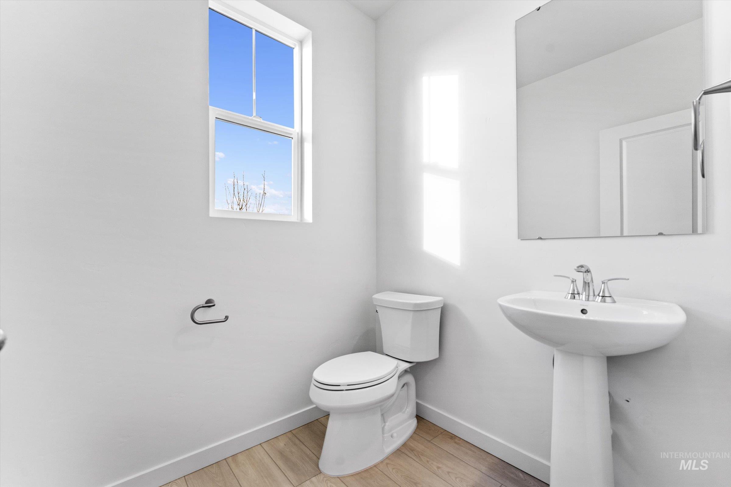 Bathroom featuring baseboards and light wood-style floors