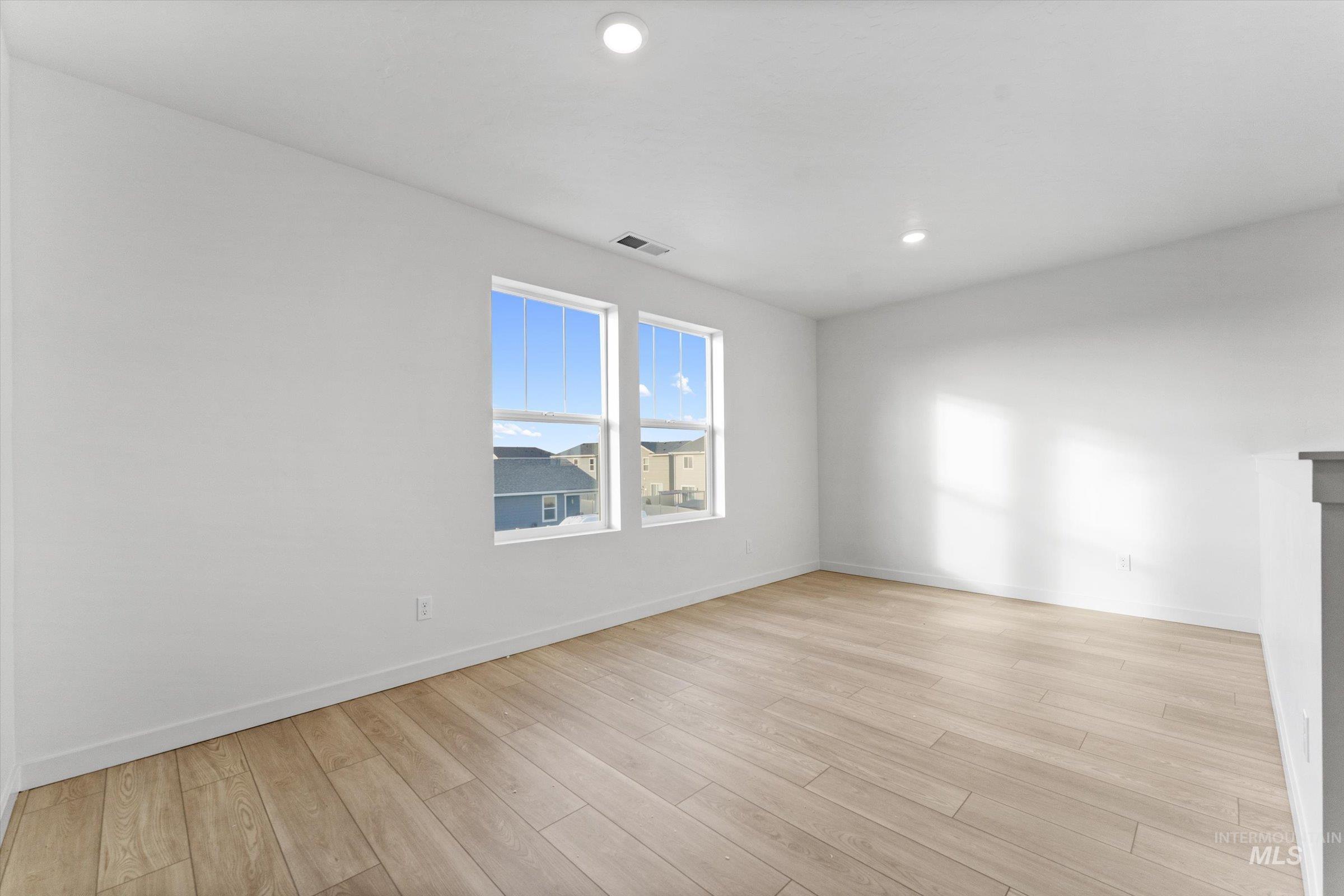 Unfurnished room with light wood finished floors and recessed lighting