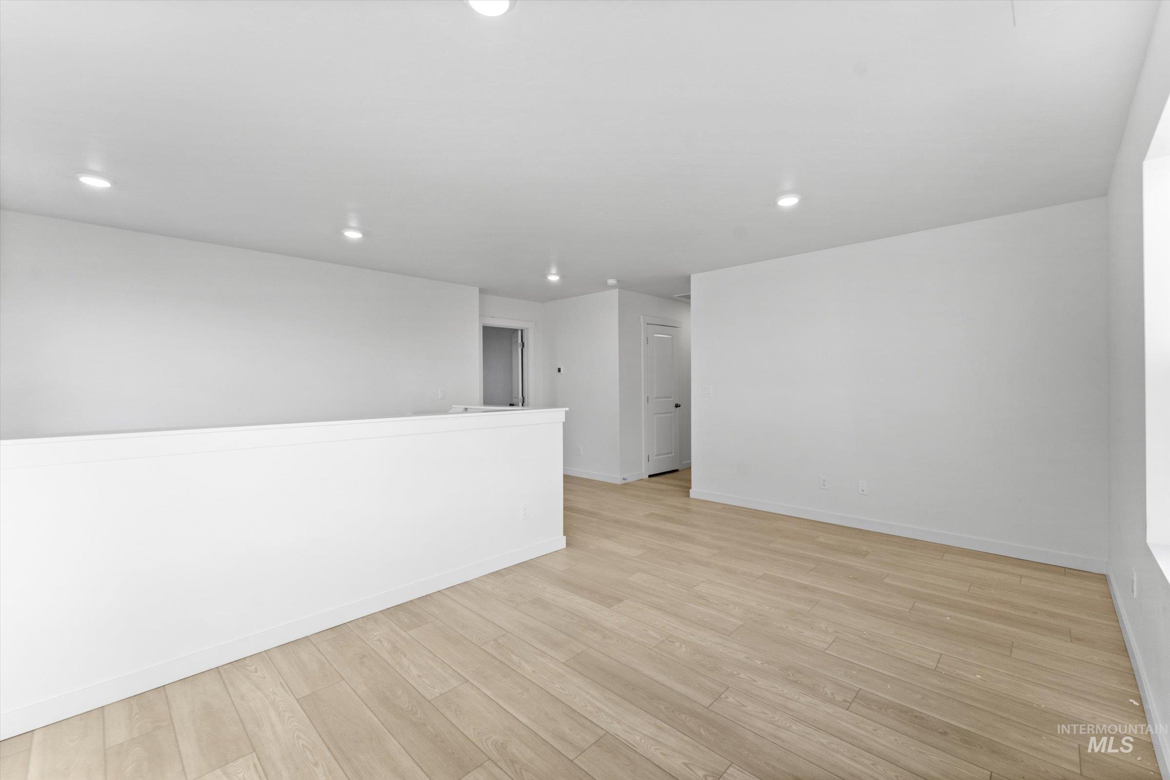 Spare room with light wood-style flooring and recessed lighting